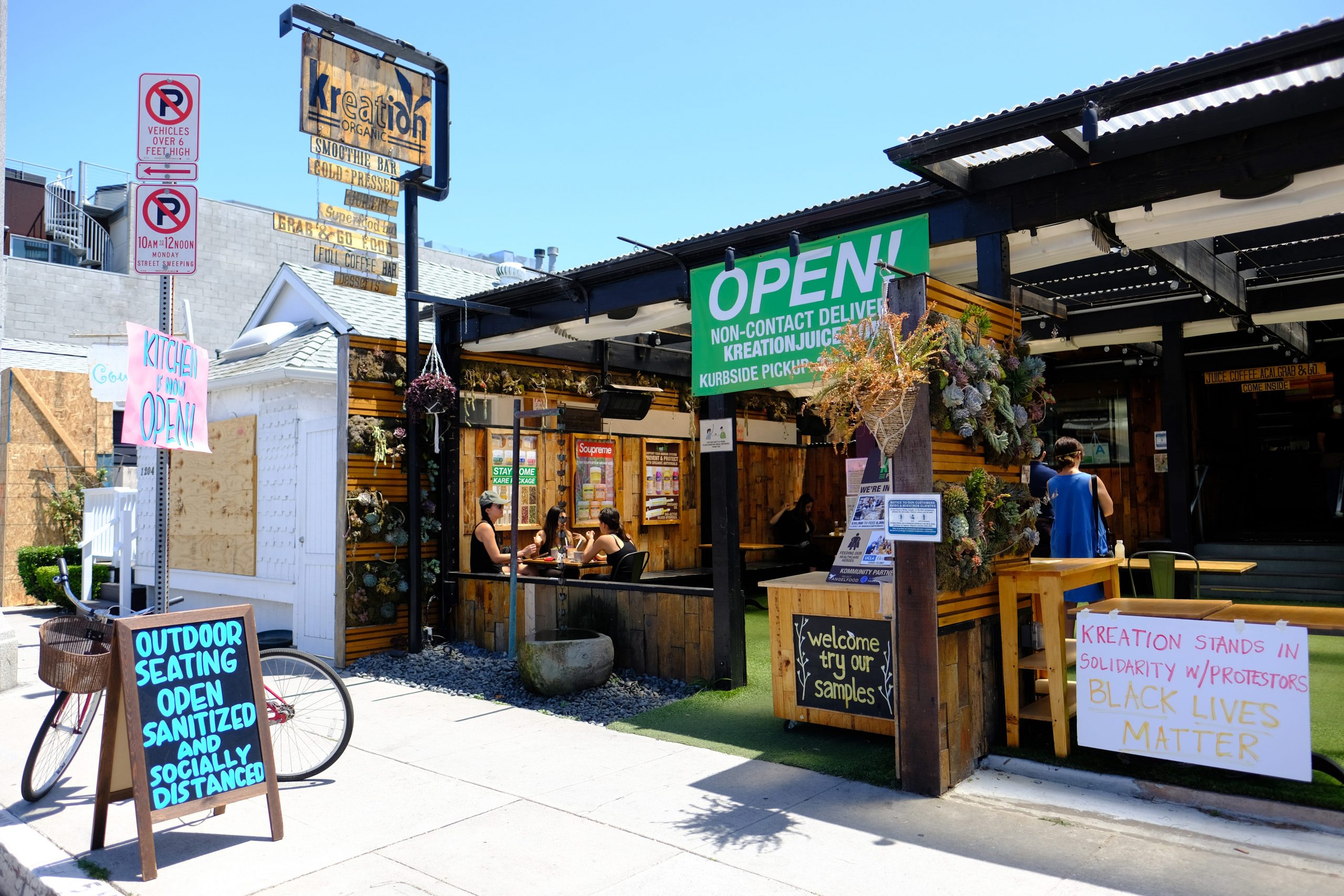 Customers are seen dining on the outdoor patio of Kreation Organic Kafe & Juicery