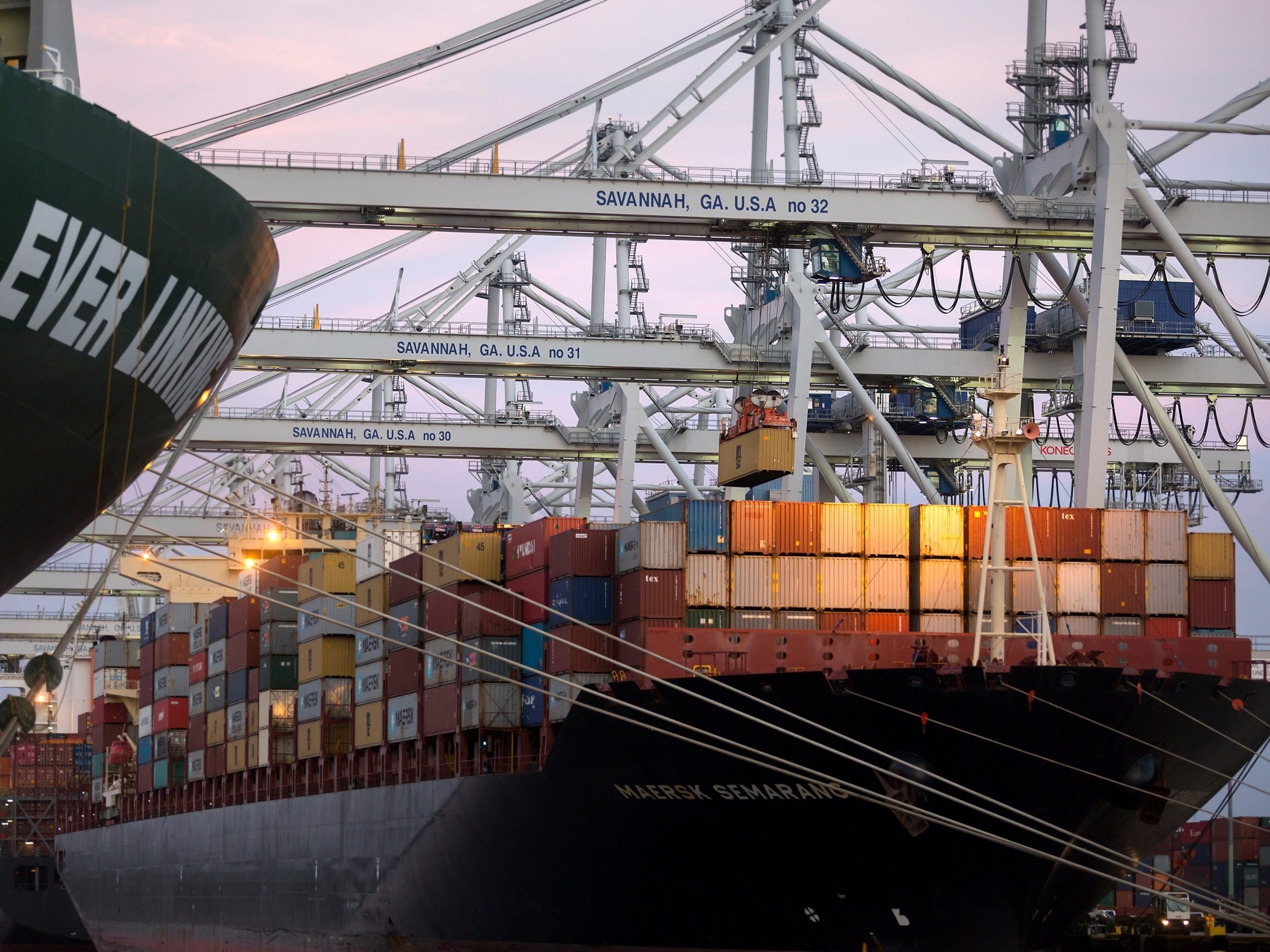 In this June, 19, 2018 photo, several ship to shore cranes stack shipping containers on-board the container ship Maersk Semarang at the Port of Savannah in Savannah, Ga.