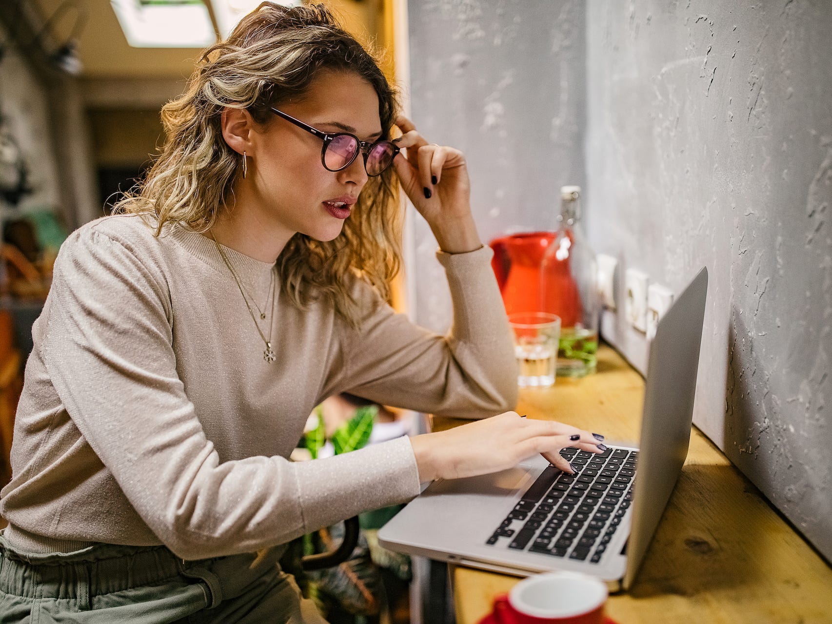 Woman looking at laptop.