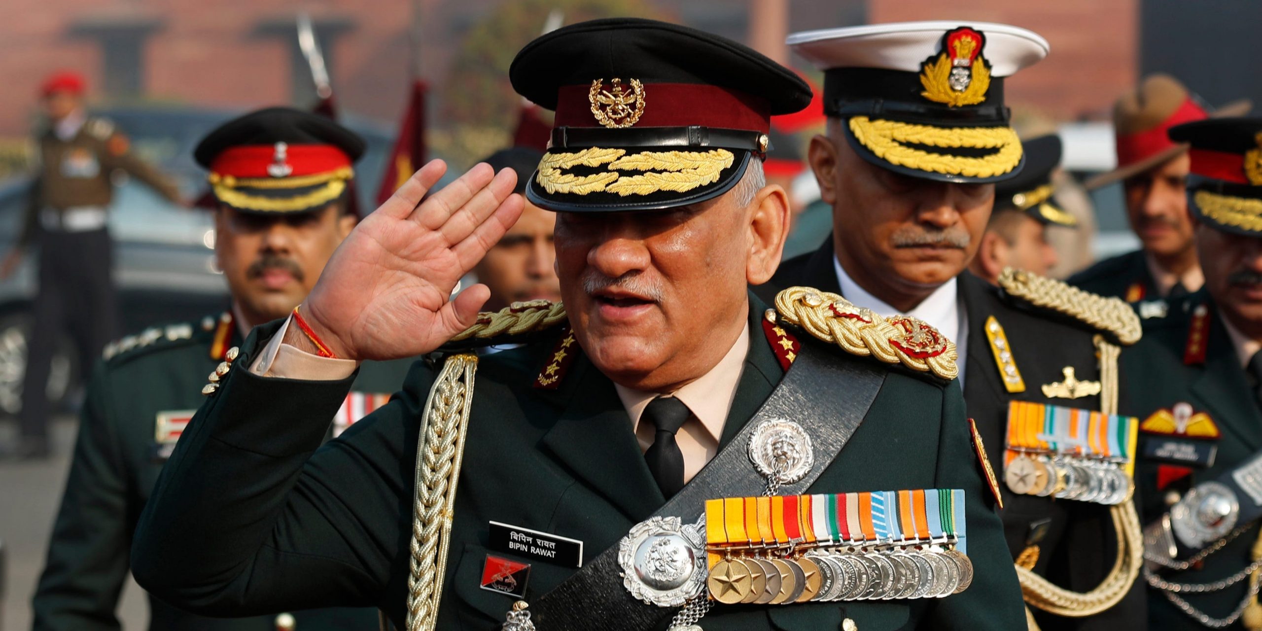 India's Chief of Defense Staff, Bipin Rawat, salutes troops while wearing uniform