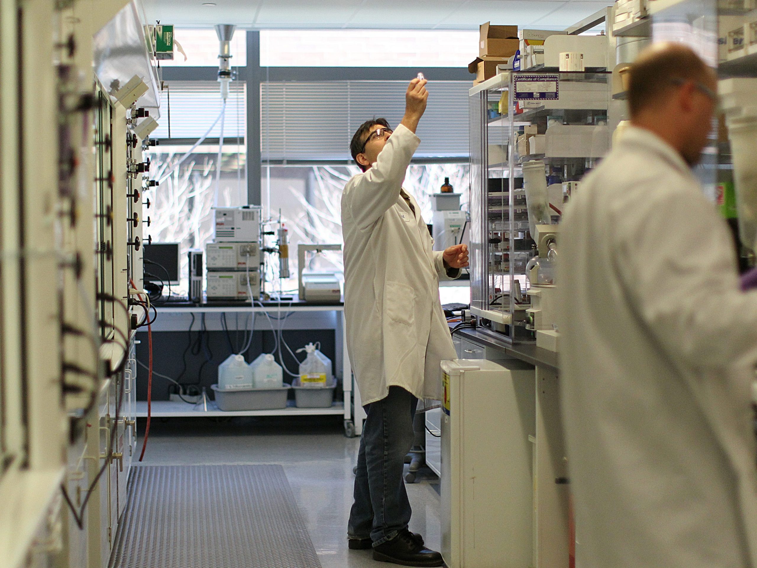 A Biogen employee works in the company's lab