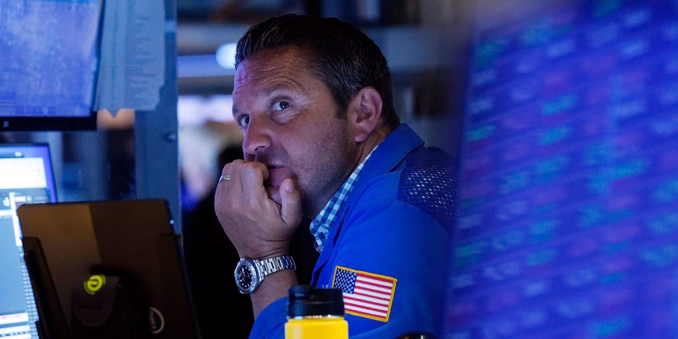 A trader sits in front of a computer monitor on the floor of the New York Stock Exchange.