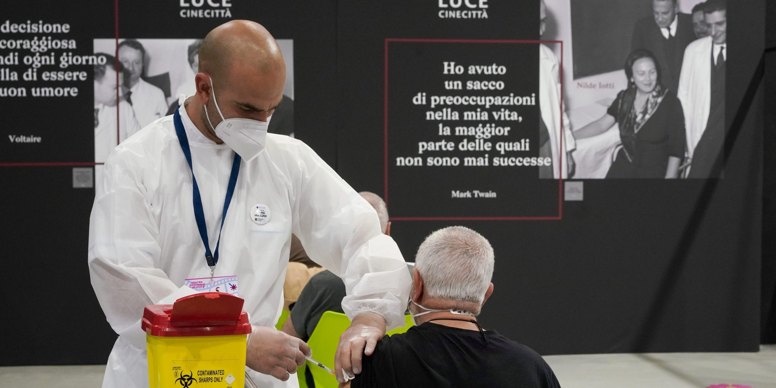 A nurse administers a COVID-19 vaccine to an Italian man.