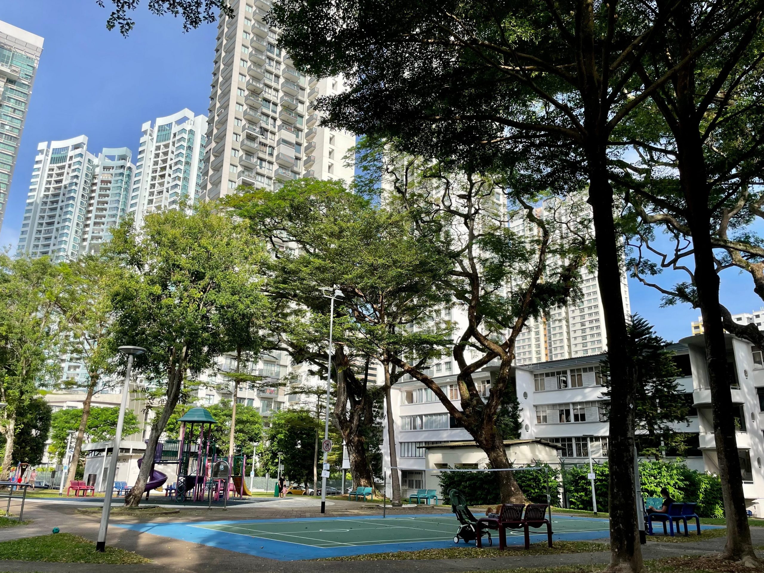 badminton court in singapore with high-rise buildings in the background and surrounded by trees