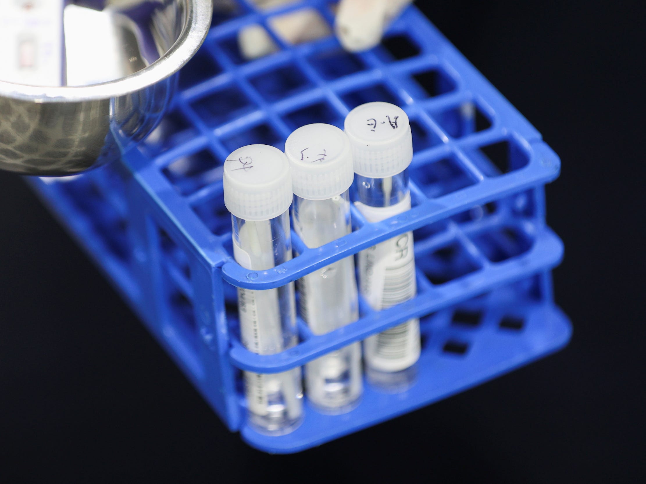 A medical worker carries RT-PCR swab tests at a pre-departure coronavirus disease (COVID-19) testing facility, as countries react to the new coronavirus Omicron variant, outside the international terminal at Sydney Airport in Sydney, Australia, November 29, 2021.