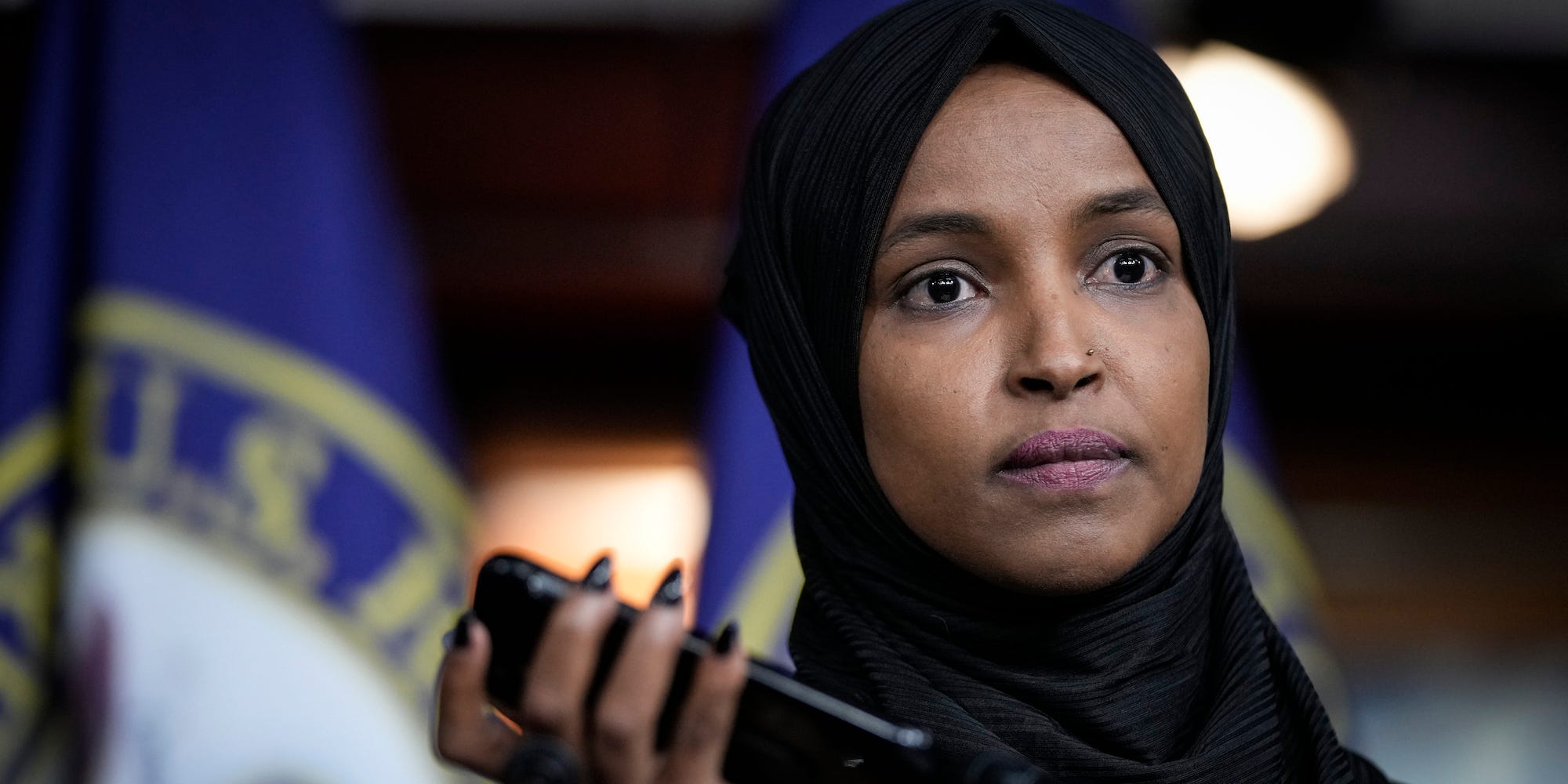 Democratic Rep. Ilhan Omar of Minnesota plays a voicemail containing an Islamophobic death threat at a press conference on Capitol Hill on November 30, 2021.