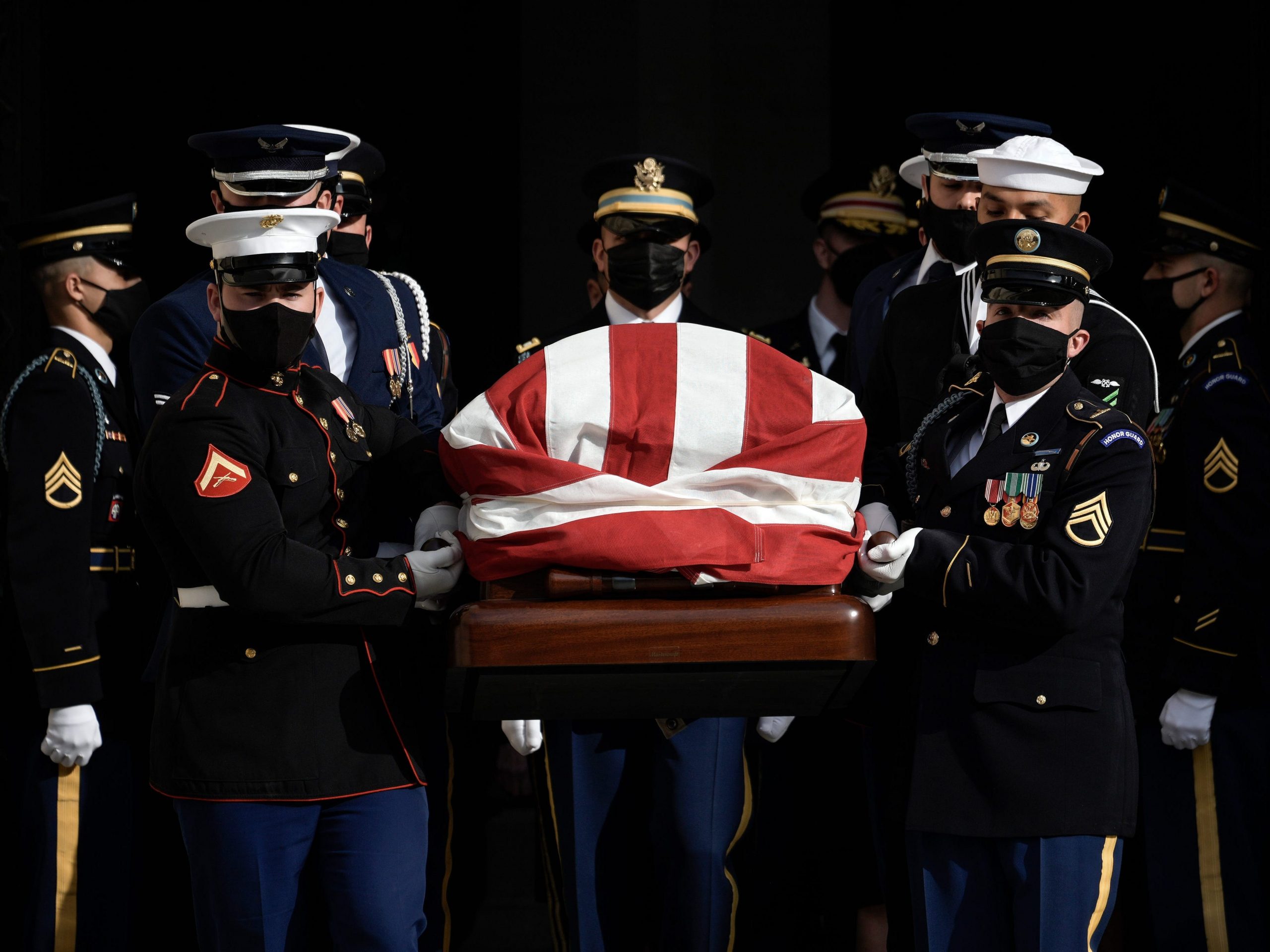 A military honor guard carries the casket of the late former Senator Robert Dole (R-KS) at the conclusion of his funeral service at Washington National Cathedral on December 10, 2021 in Washington, DC.