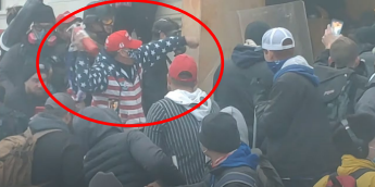 Capitol riot defendant Robert Palmer throwing a fire extinguisher.