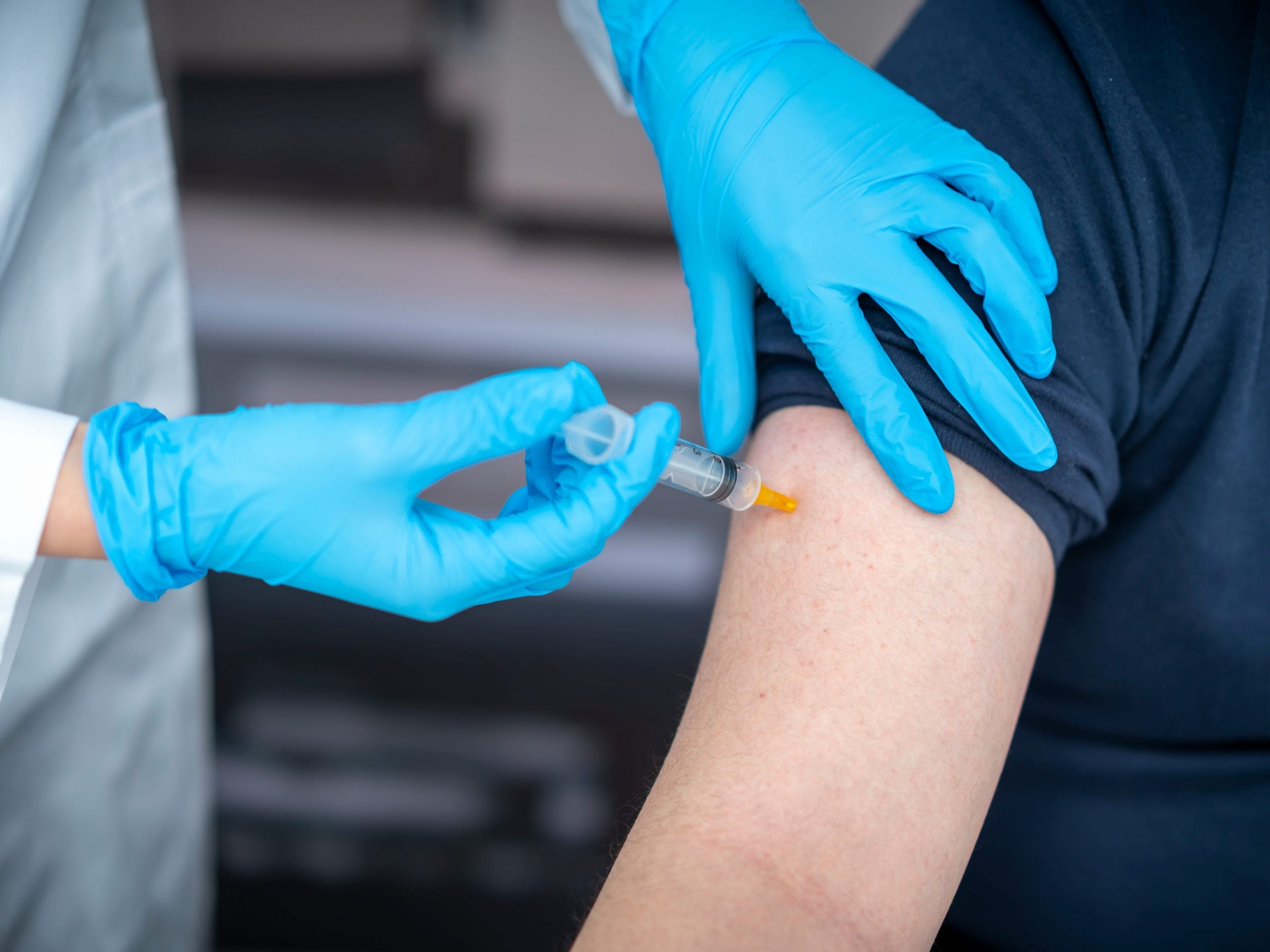 Man receives vaccine in arm