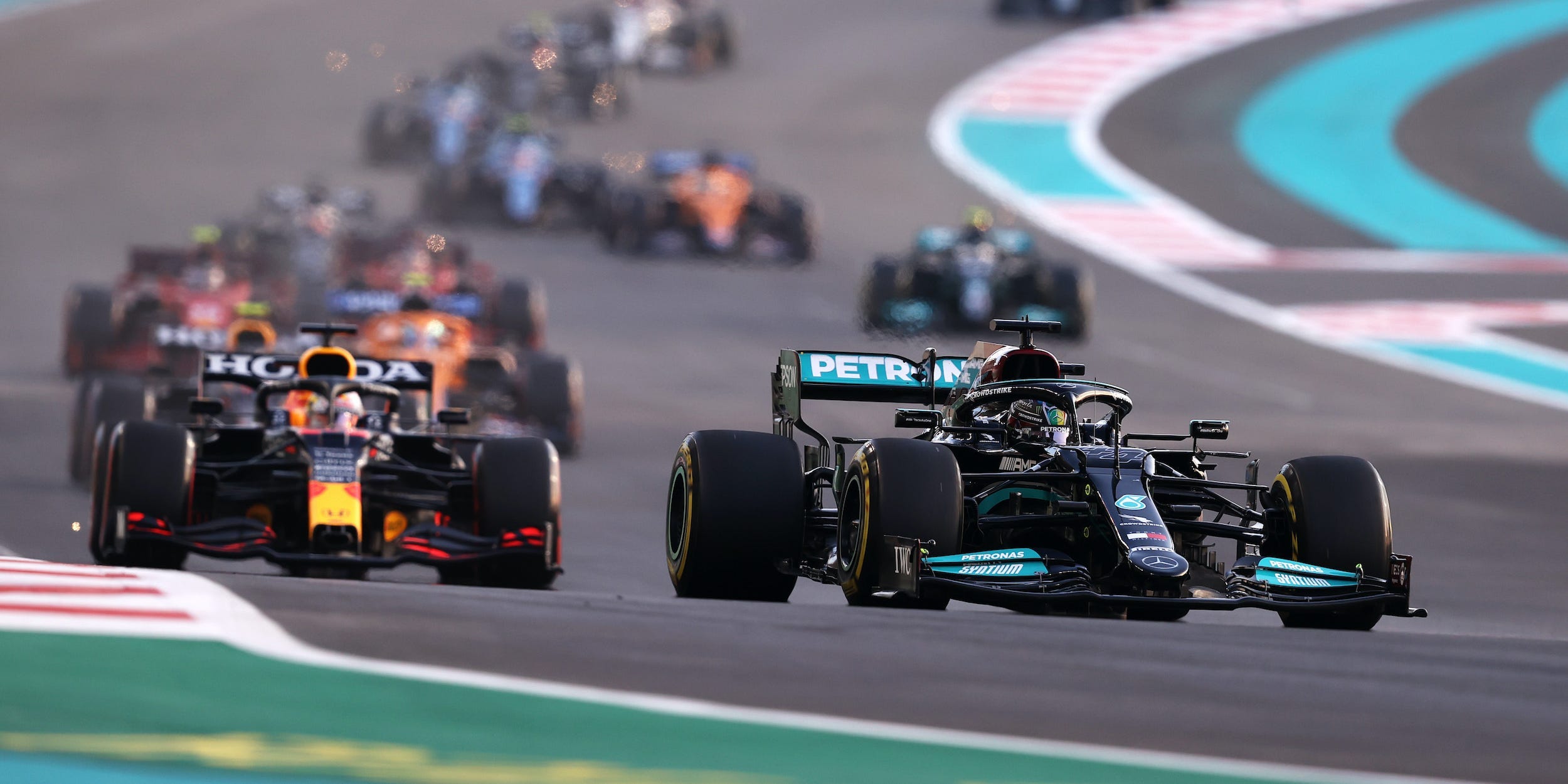 Lewis Hamilton and Max Verstappen seen racing during the 2021 Abu Dhabi Grand Prix.