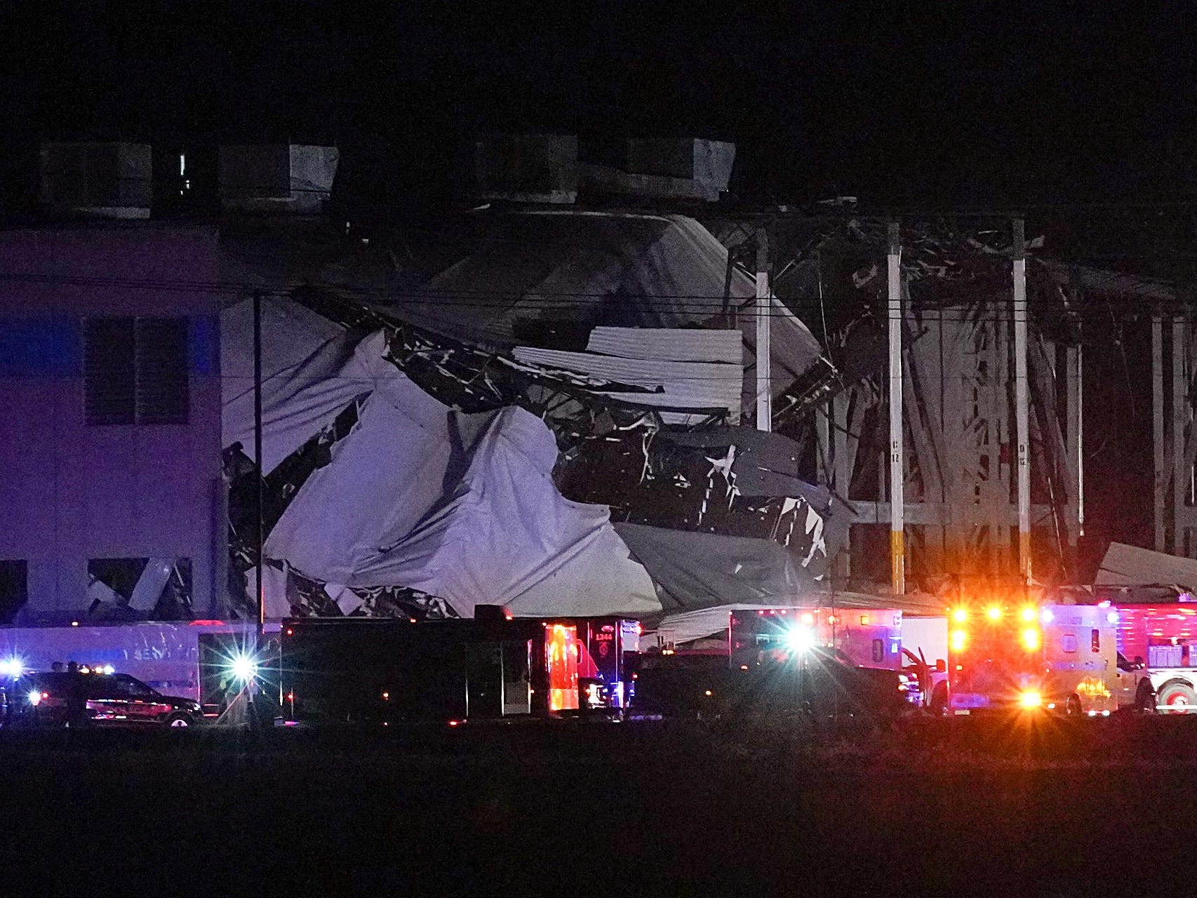 Emergency vehicles surround the site of an Amazon distribution warehouse in Edwardsville, Illinois with a collapsed roof, after storms hit the Midwest. December 10, 2021.