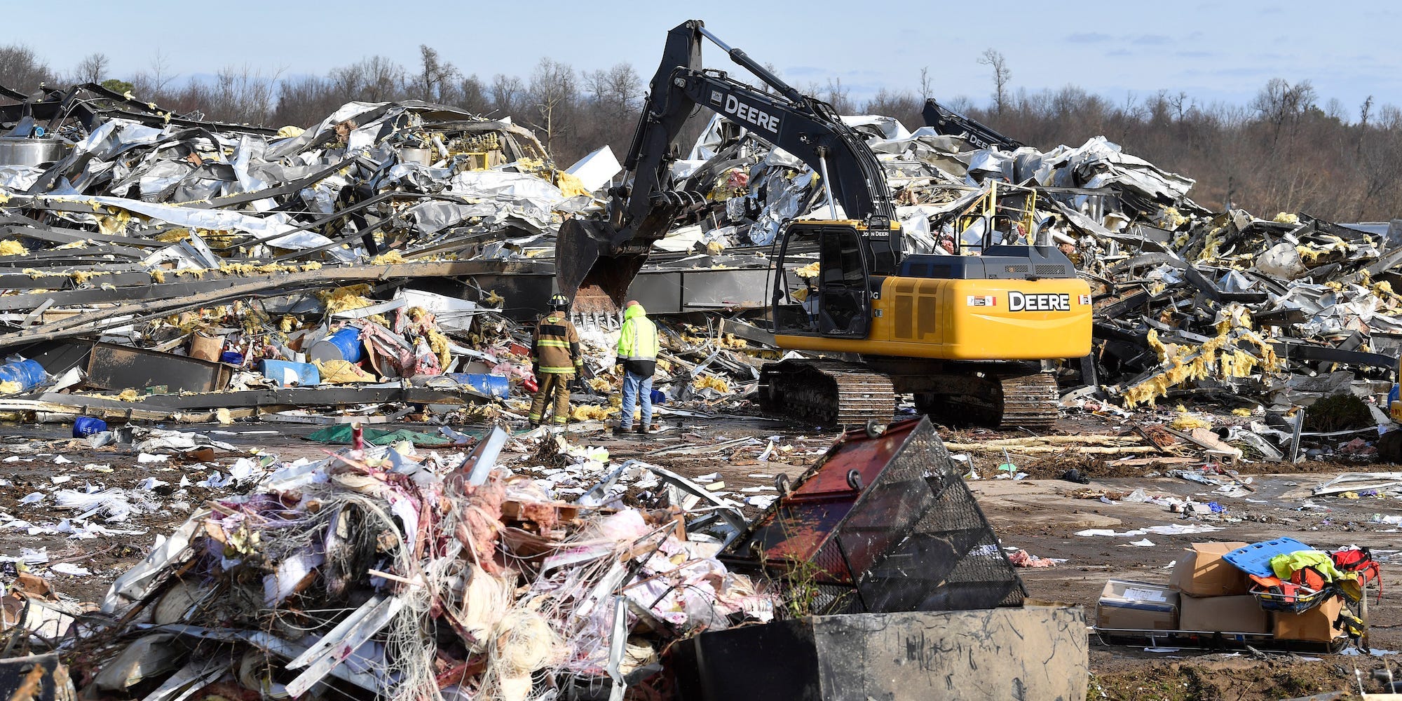 Emergency response workers dig through the rubble of the Mayfield Consumer Products candle factory in Mayfield, Ky., Saturday, Dec. 11, 2021.