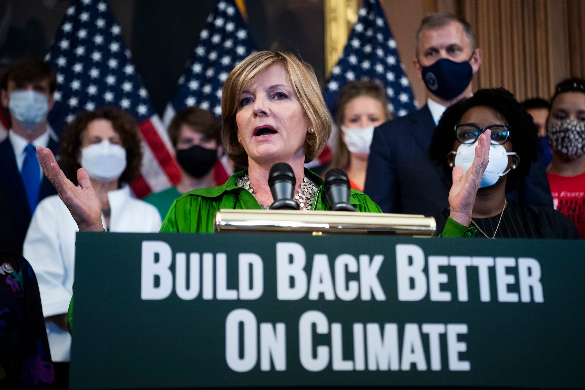 Democratic Rep. Susie Lee of Nevada, wearing a green blouse, leads a press conference on Capitol Hill about climate crisis issues and the Biden agenda.