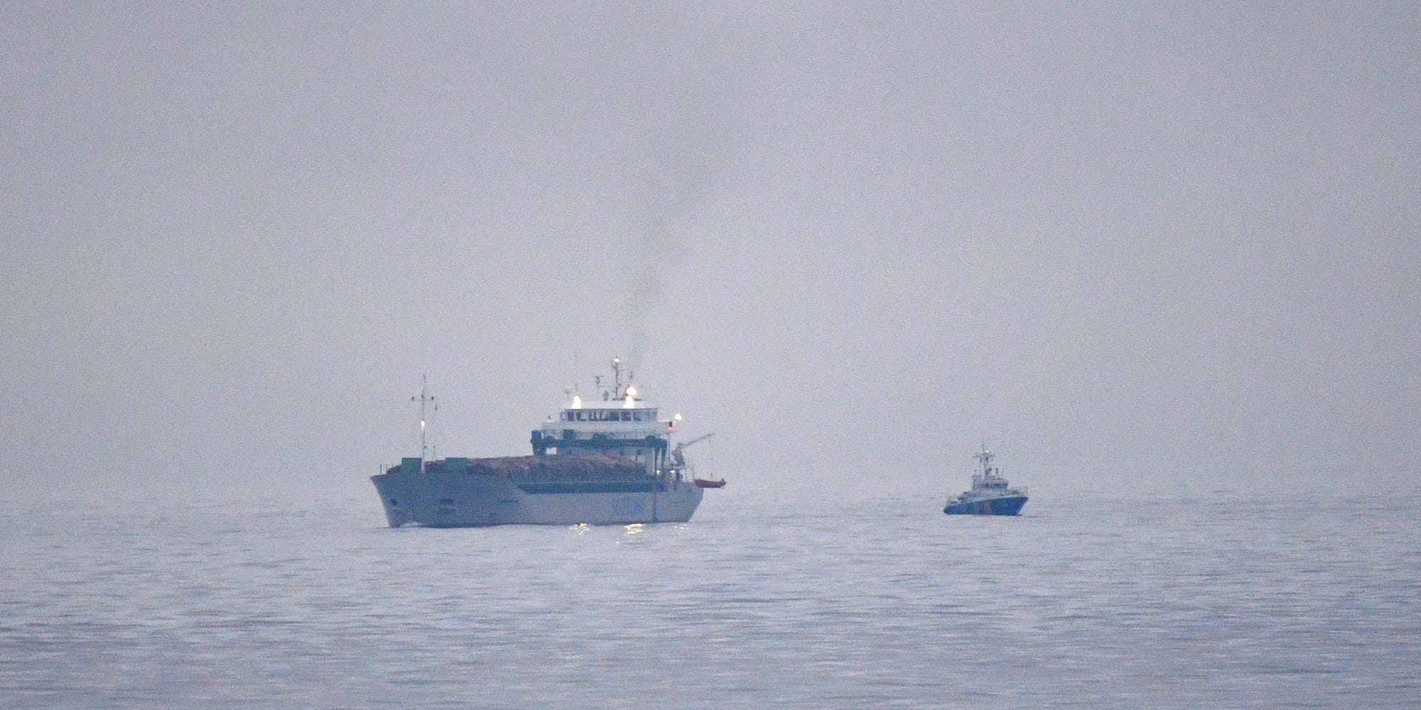 A ship in the Baltic Sea with a rescue vessel nearby, December 2021.