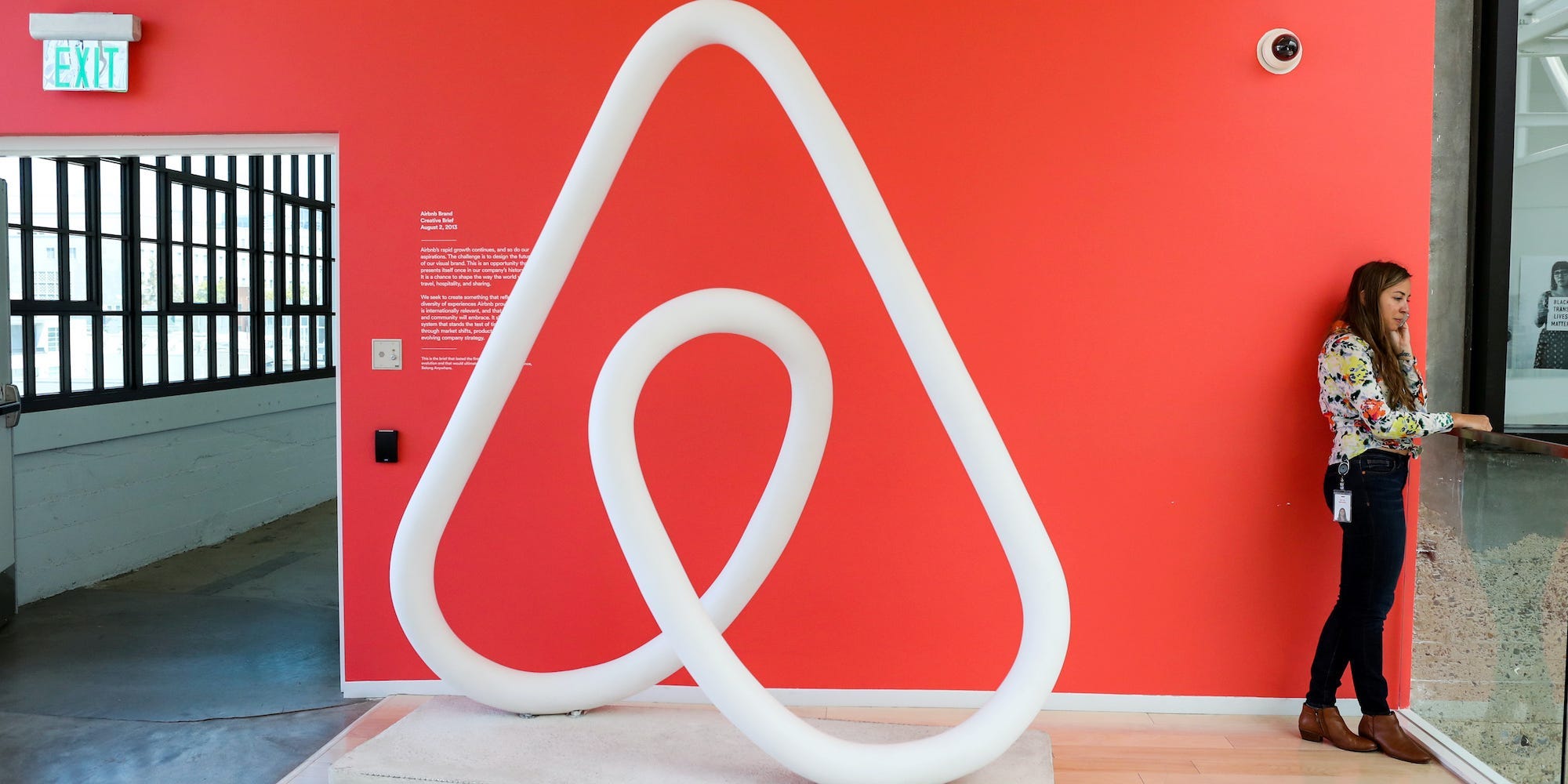 A woman talks on the phone at the Airbnb office headquarters in the SOMA district of San Francisco.