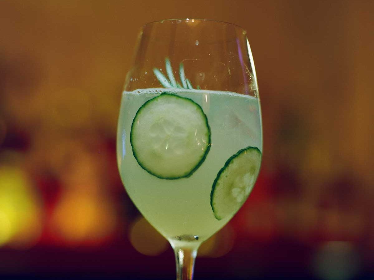 A cocktail with cucumbers in it