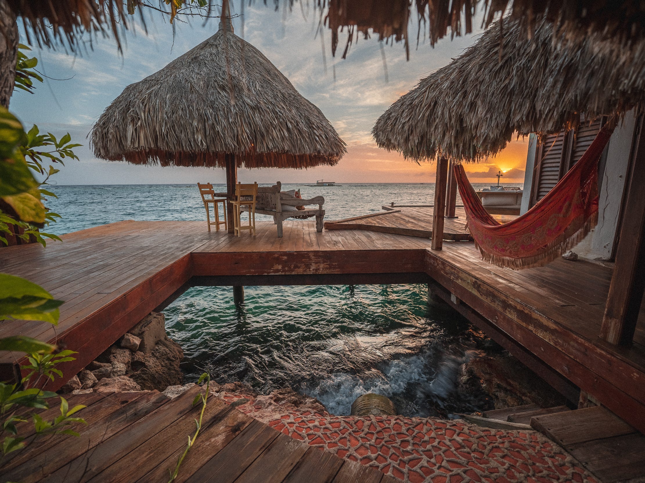 An overwater bungalow at Aruba Ocean Villas at sunset.