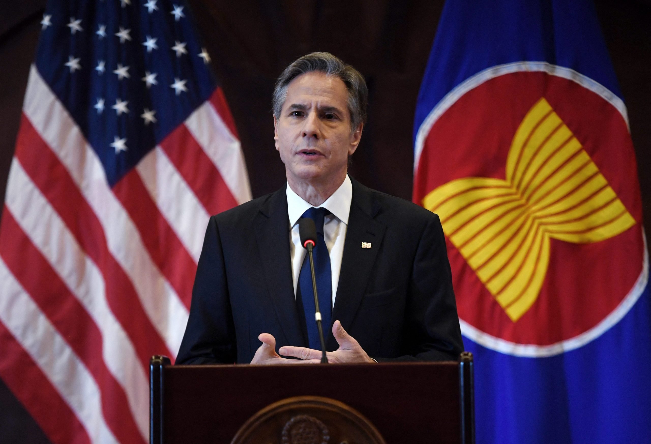 Antony Blinken speaks at a podium in front of a US flag and ASEAN flag