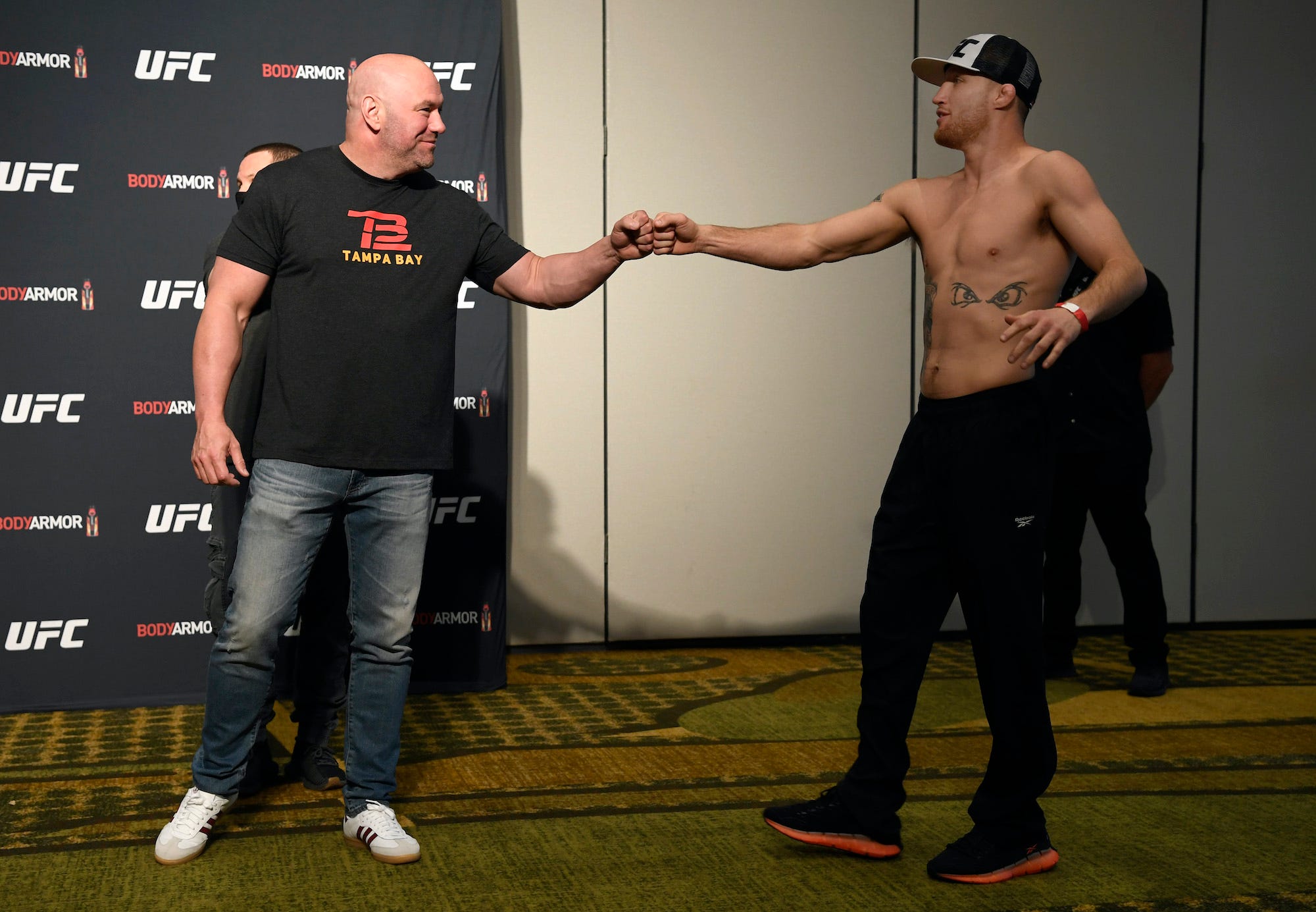 UFC boss Dana White fist-bumps Justin Gaethje at a weigh-in event.