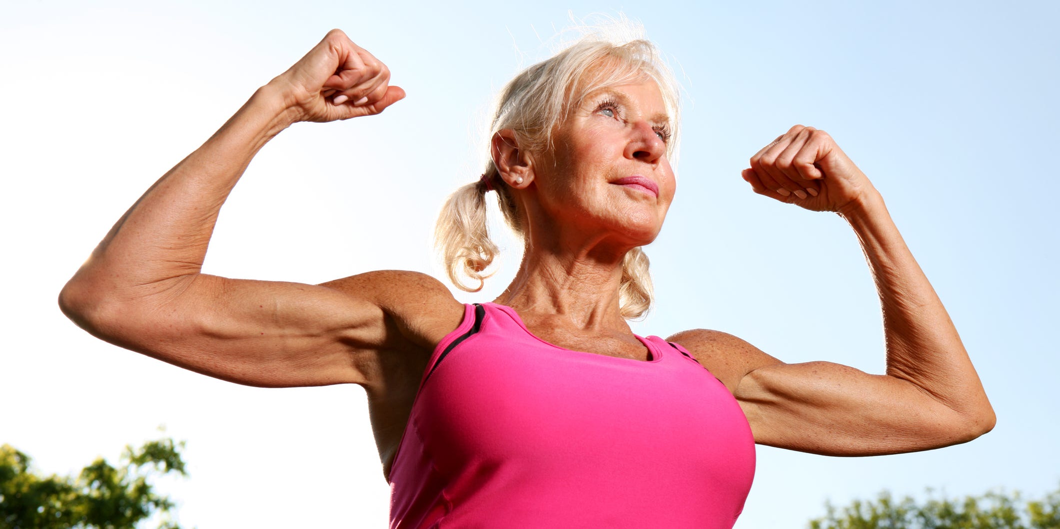 A woman flaunts her bicep muscles.