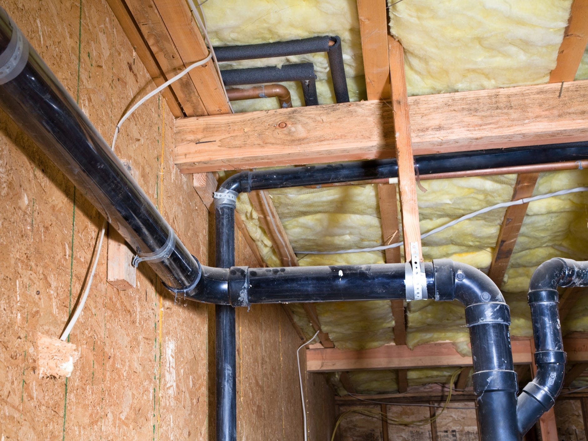 Exposed pipes in a crawl space