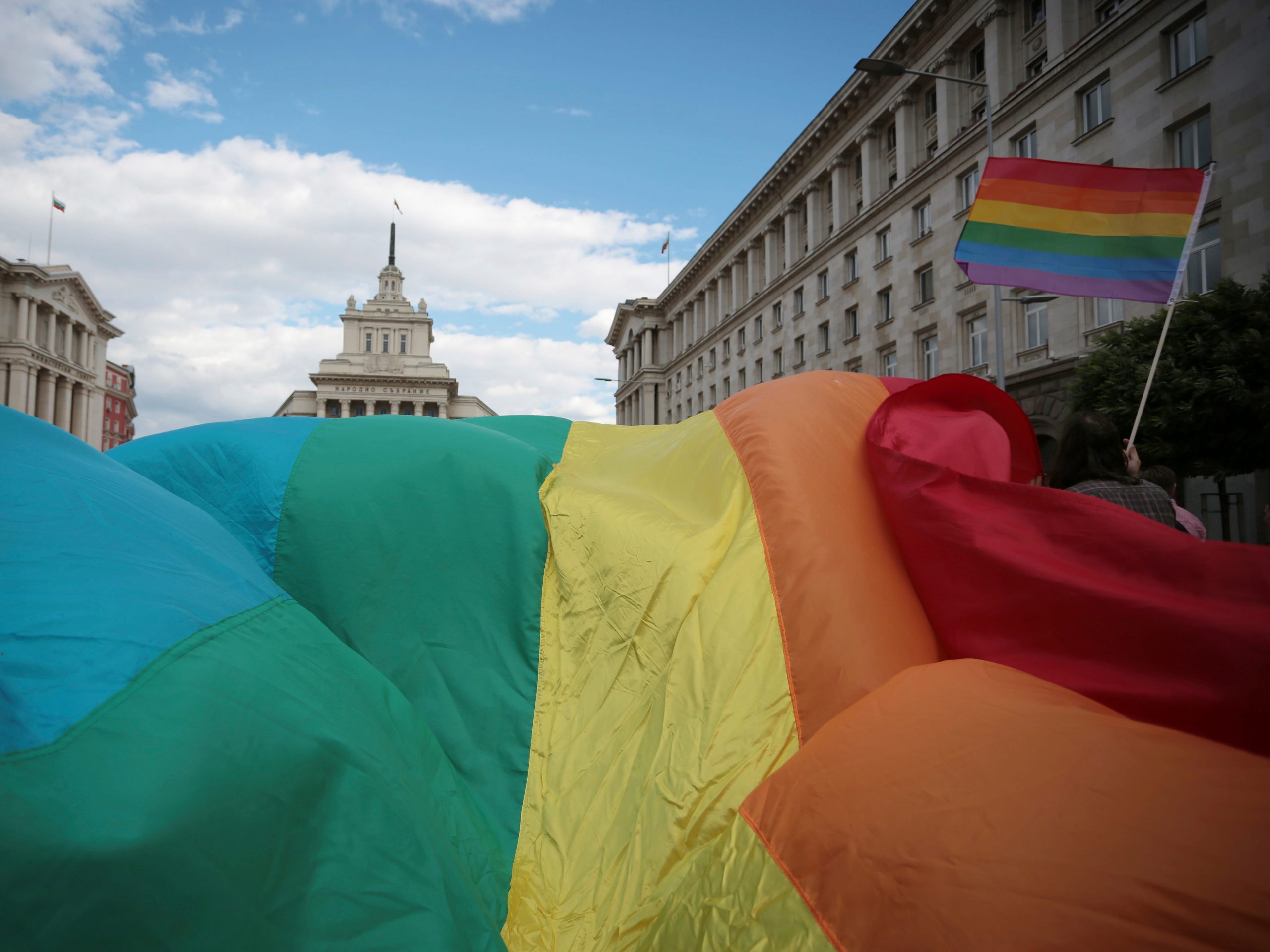 An activist carries the rainbow flag during the gay pride rally in the Bulgarian capital of Sofia, Sept. 21, 2013. A ruling by the European Union's top court on Tuesday, Dec. 14, 2021 has given a boost to the rights of same-sex parents and their children in the 27-nation bloc.