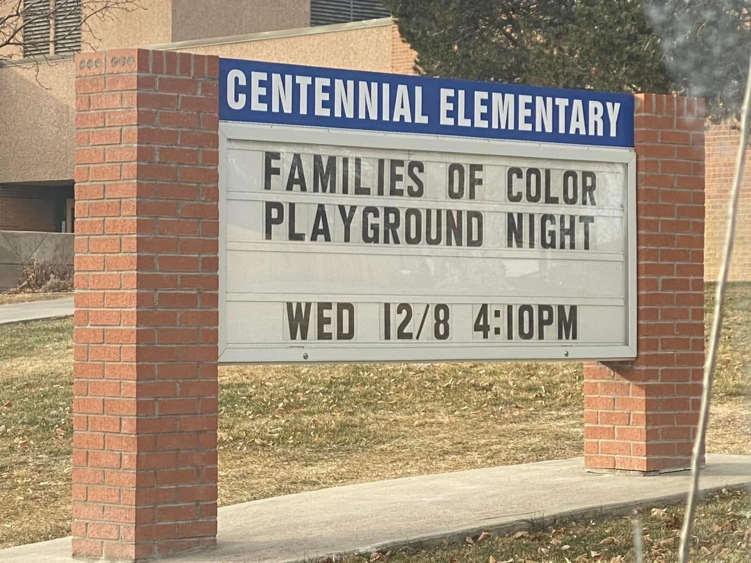 Sign saying "Families of Color Playground Night" outside the Centennial Elementary School in Denver.