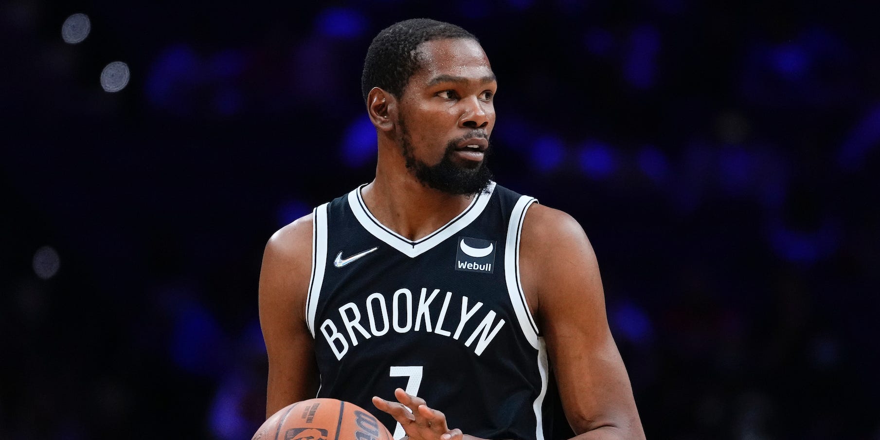 Kevin Durant holds the ball and looks on during a game.