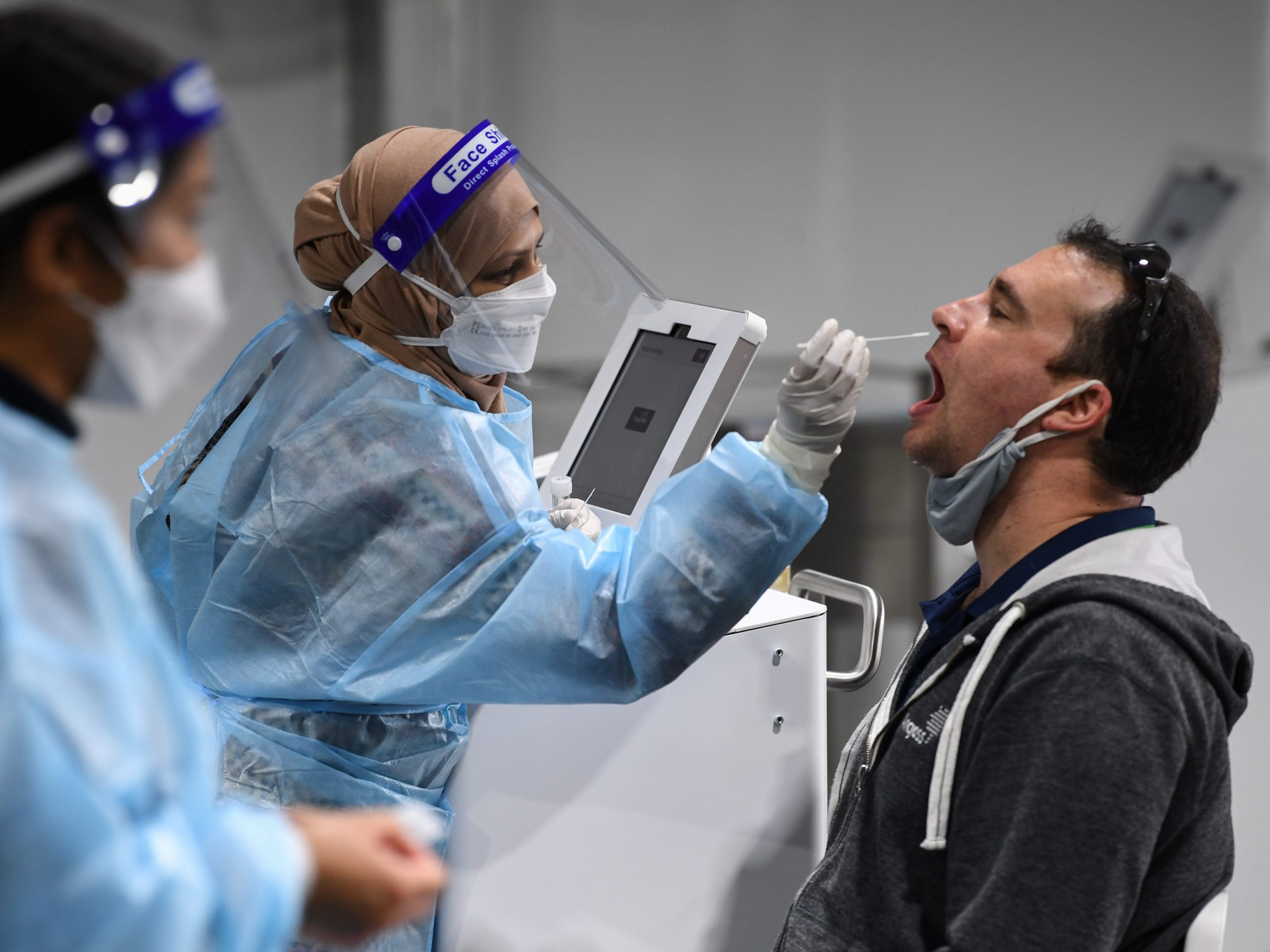 A man receives a omicron covid-19 test at an airport