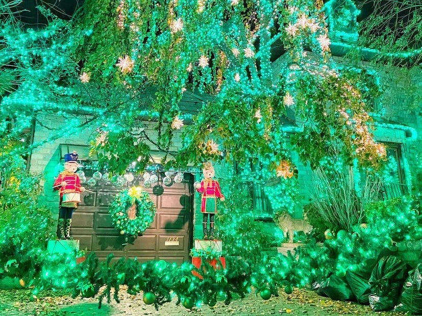 a green lights display on a house in Dyker Heights Brooklyn