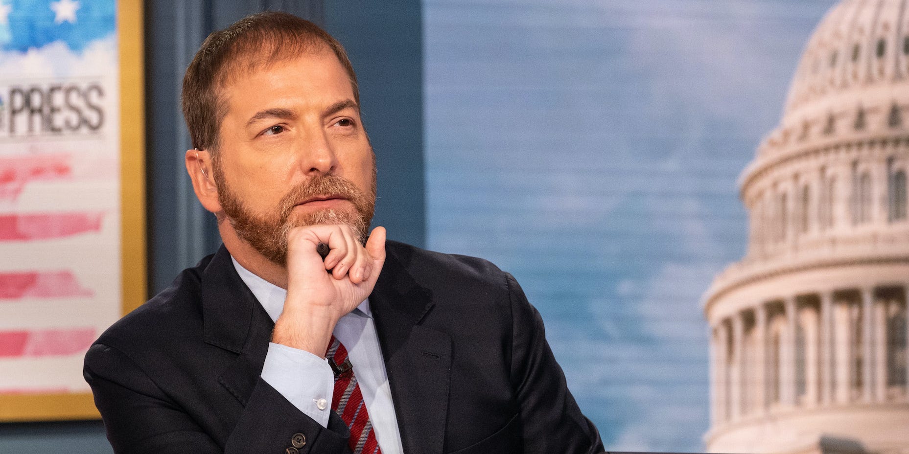 NBC "Meet the Press" moderator Chuck Todd holds his fist to his chin in a pensive look.