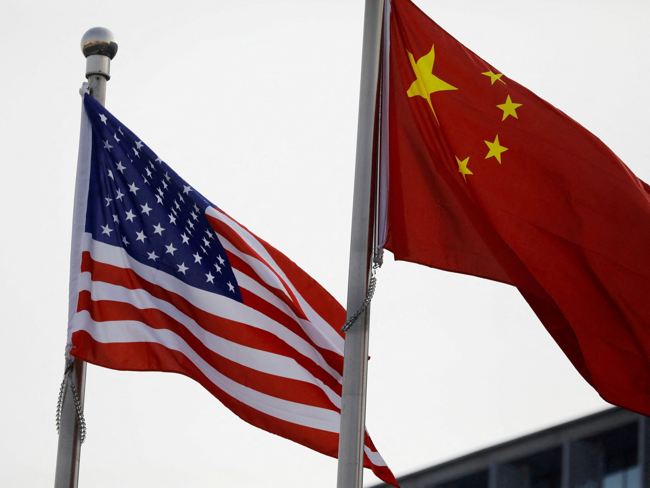 Chinese and US flags flutter outside the building of an American company in Beijing, China