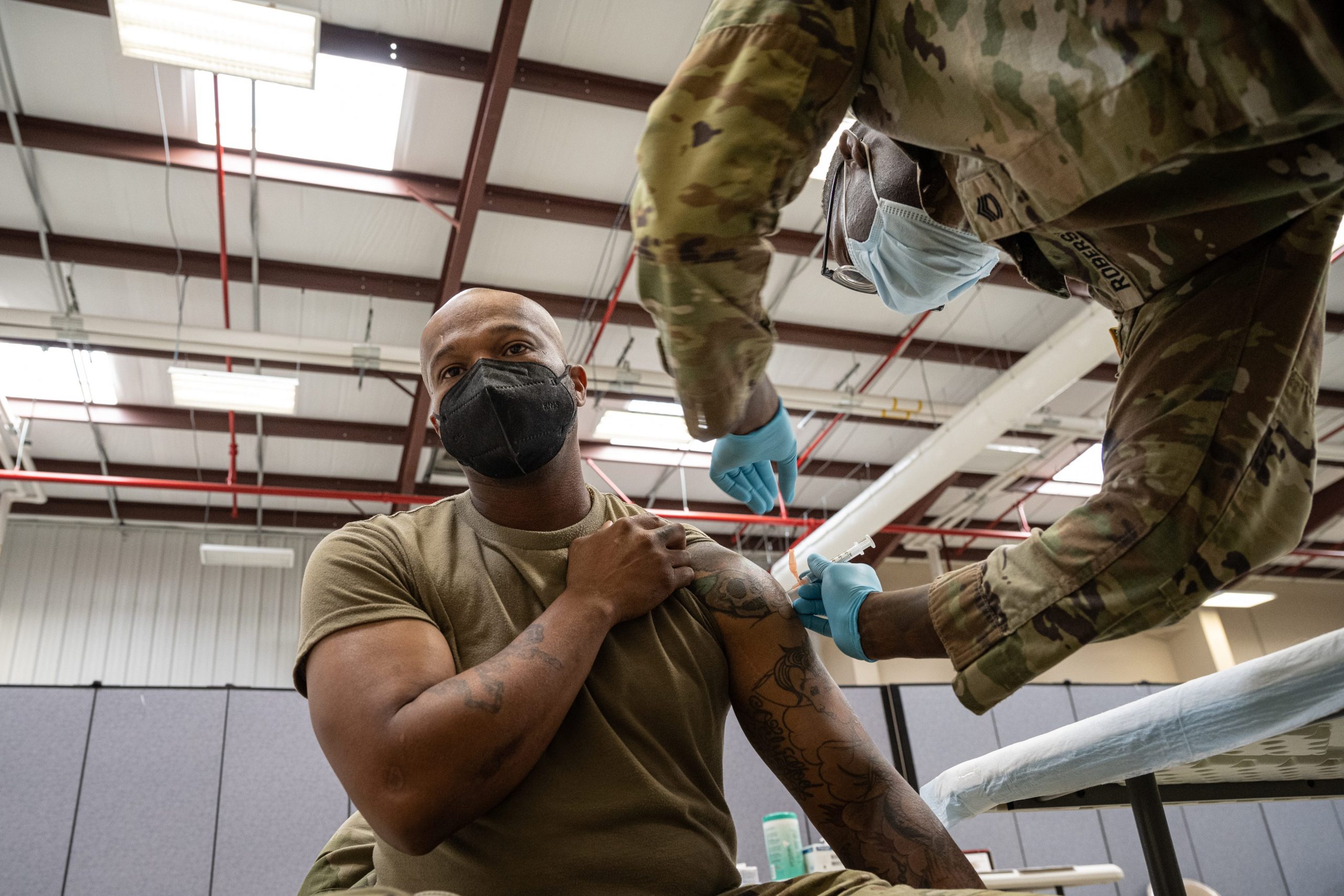 A US Army sergeant gets vaccinated in a military facility