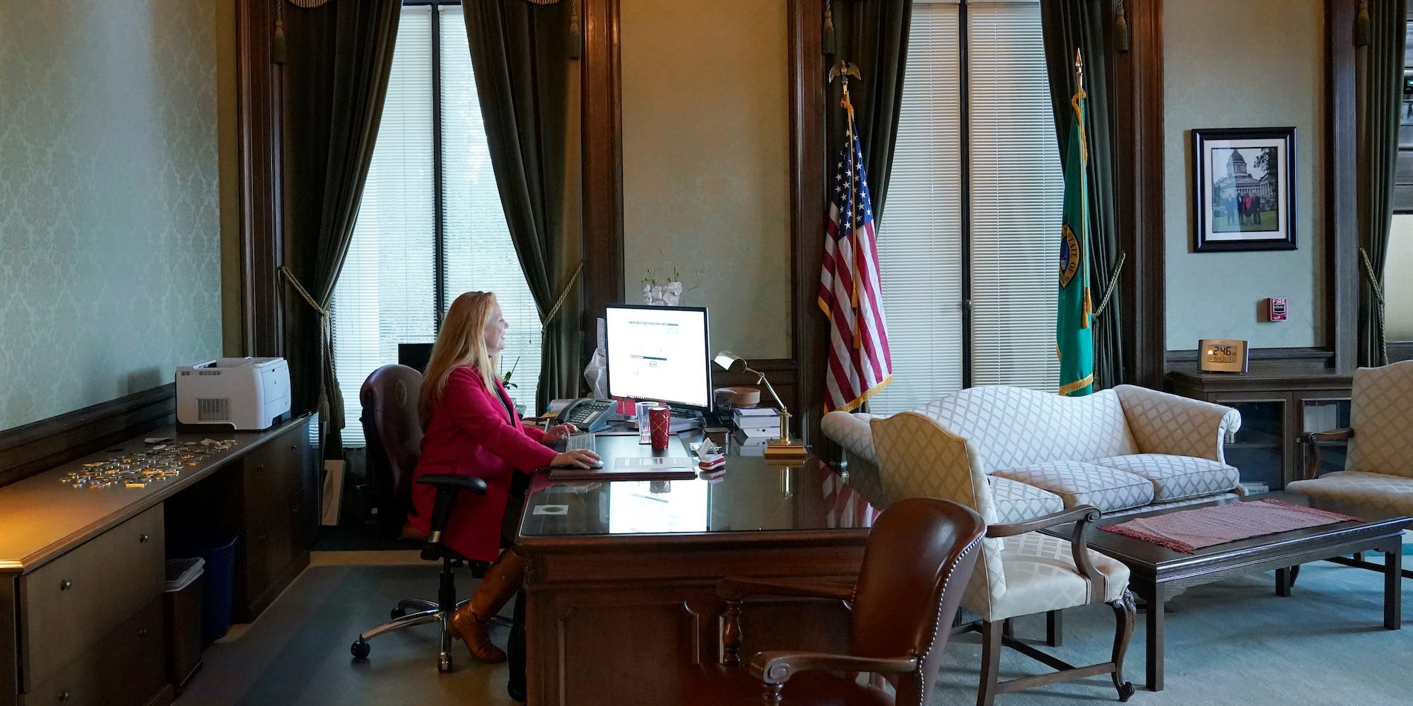 Washington Secretary of State Kim Wyman works at her desk in her office, Monday, Nov. 15, 2021, at the Capitol in Olympia, Wash.