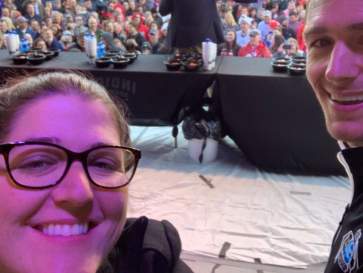 two people take a selfie behind a stage