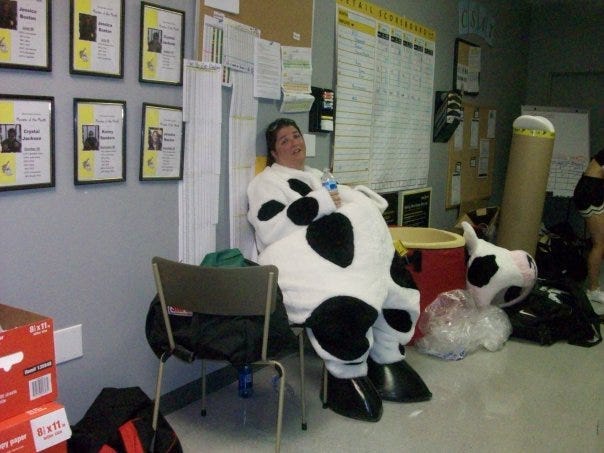 woman dressed as a cow sitting down