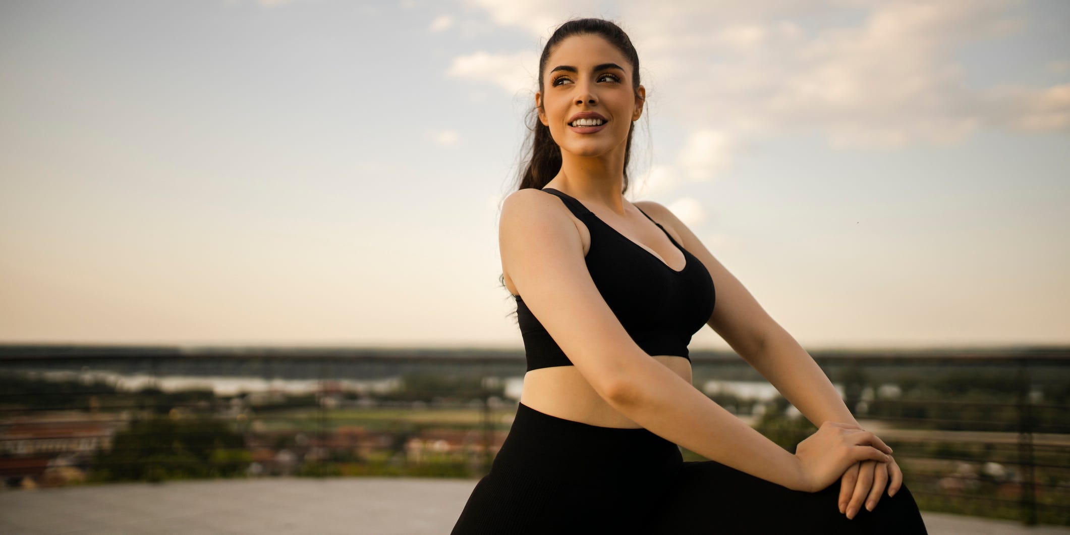 A person in workout attire stretching.