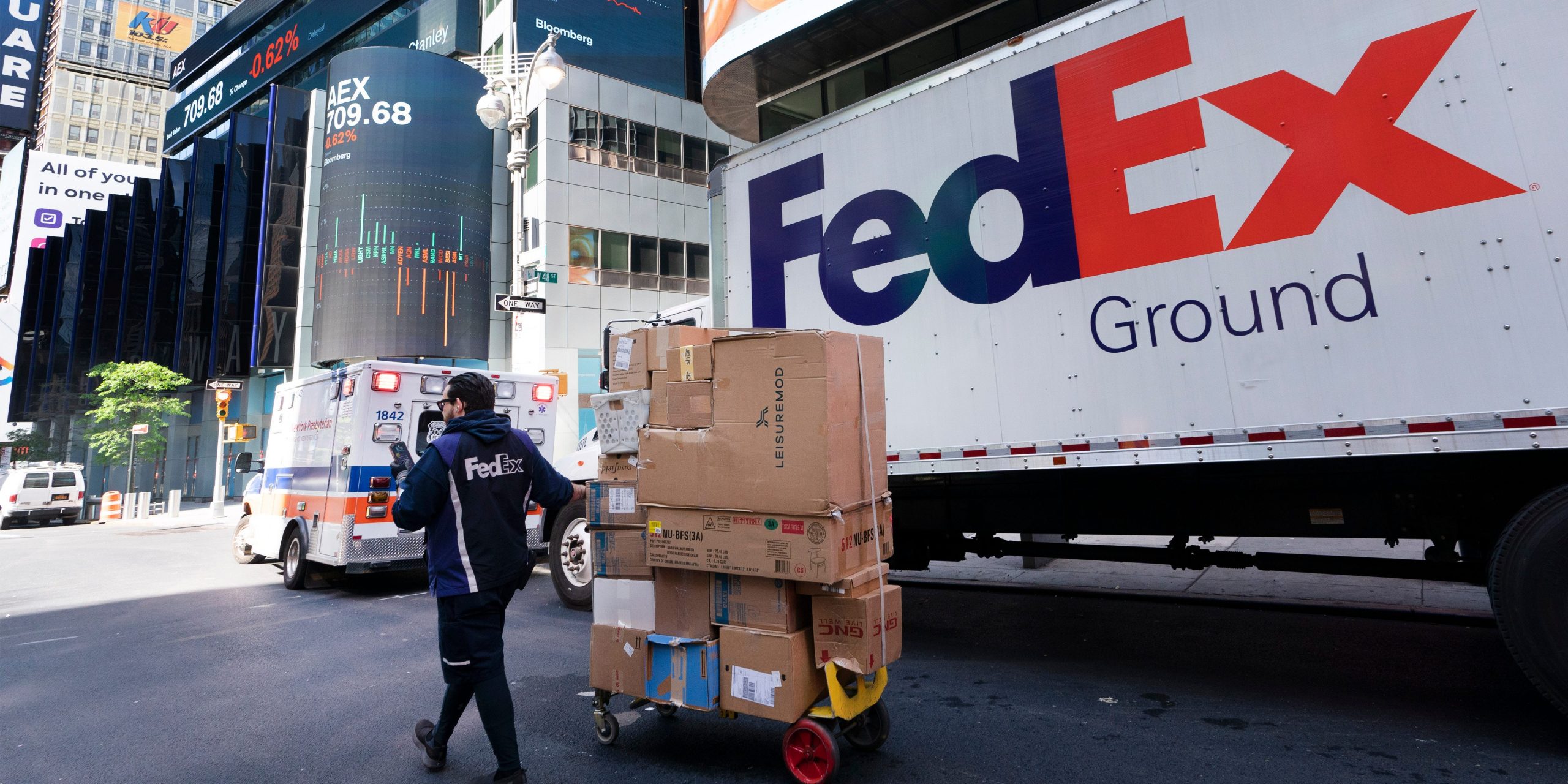 A FedEx driver delivers a cart of packages, Thursday, May 6, 2021, in New York.