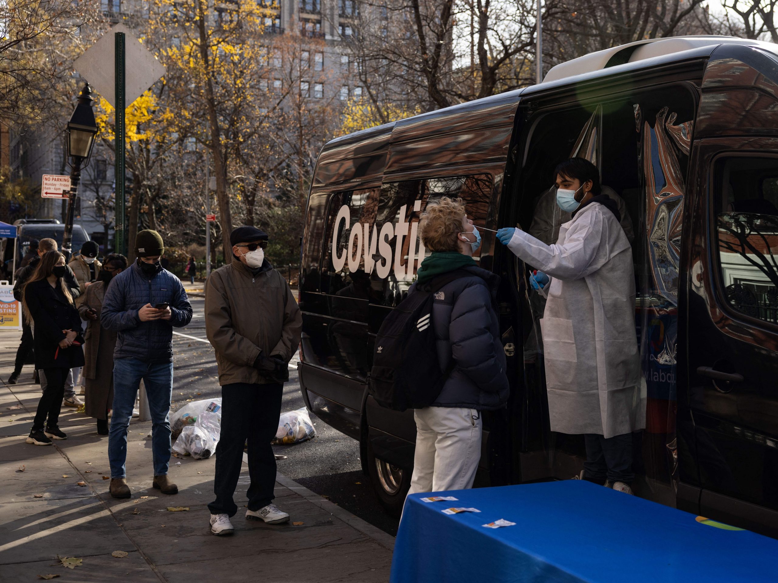 People wait in line at a mobile Covid-19 testing site on December 15, 2021 at Washington Square Park in New York City, New York.