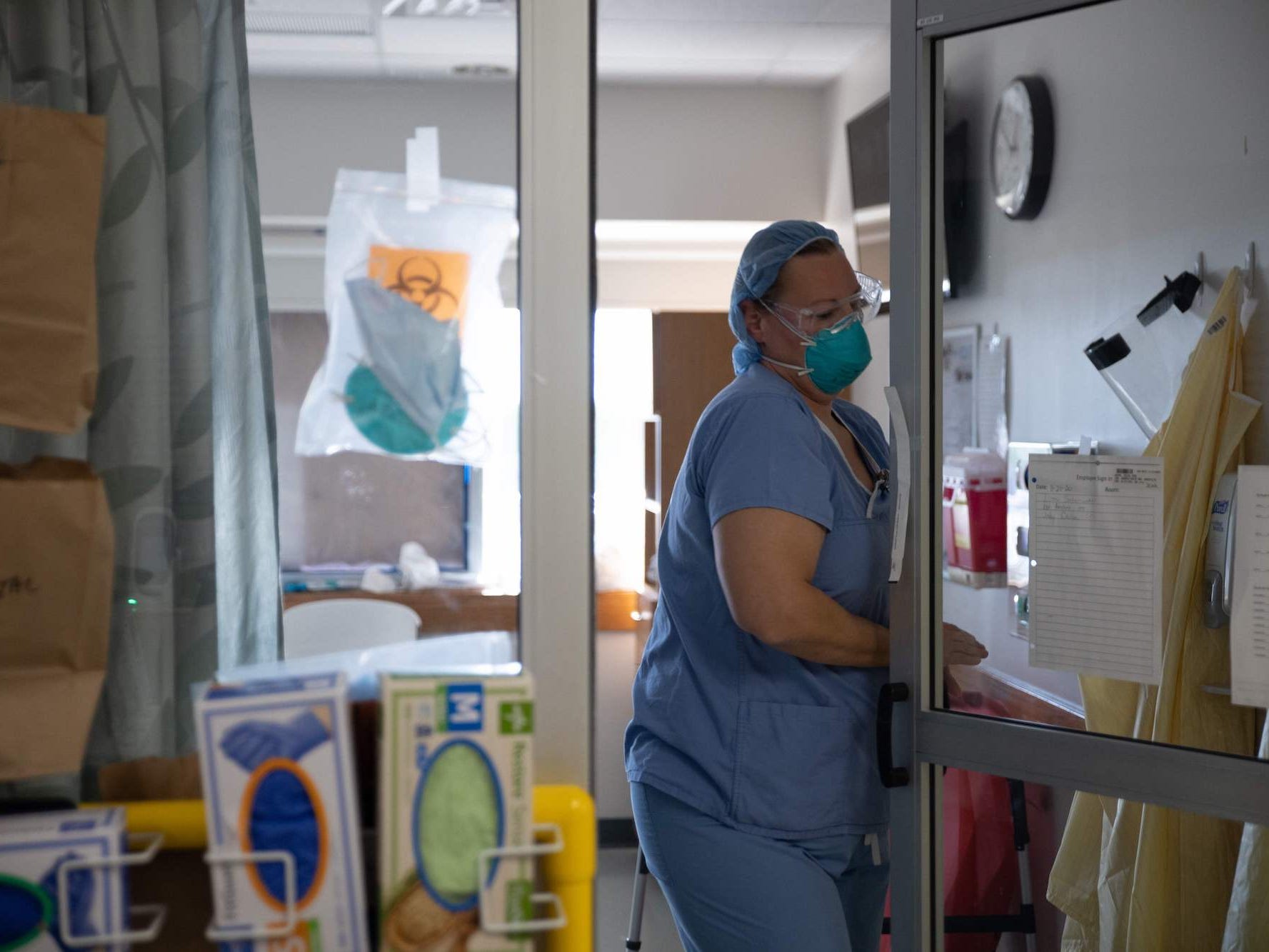 A healthcare professional exits a Covid-19 patient's room in the ICU at Van Wert County Hospital in Van Wert, Ohio on November 20, 2020.