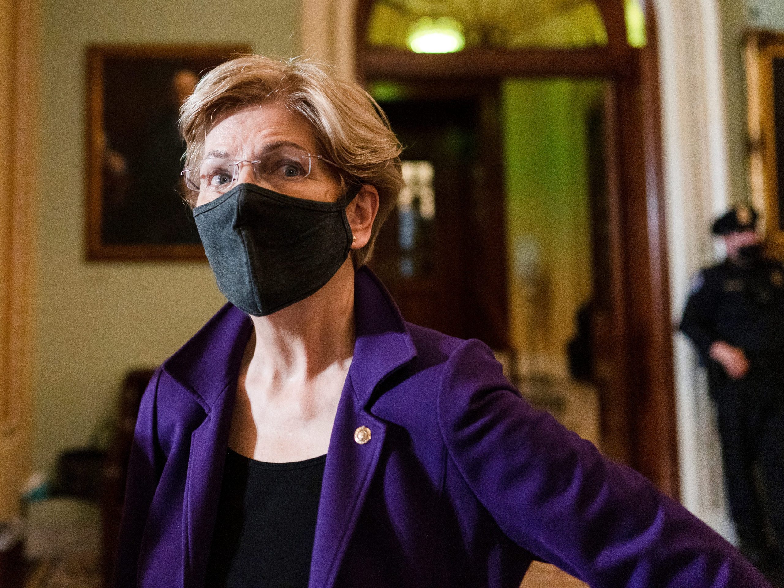 Sen. Elizabeth Warren, D-Mass., speaks to a reporter on Capitol Hill in Washington, Tuesday, Dec. 7, 2021.