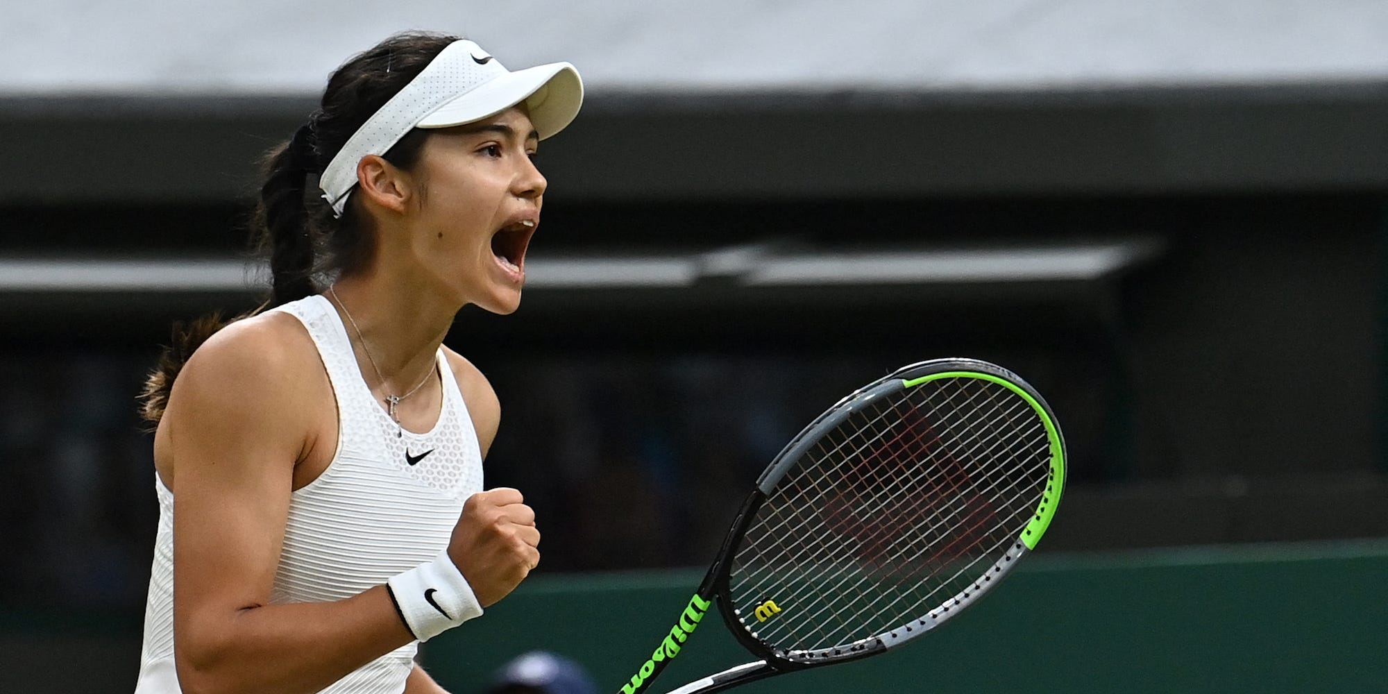 Britain's Emma Raducanu celebrates a point against Australia's Ajla Tomljanovic during their women's singles fourth round match on the seventh day of the 2021 Wimbledon Championships at The All England Tennis Club in Wimbledon, southwest London, on July 5, 2021