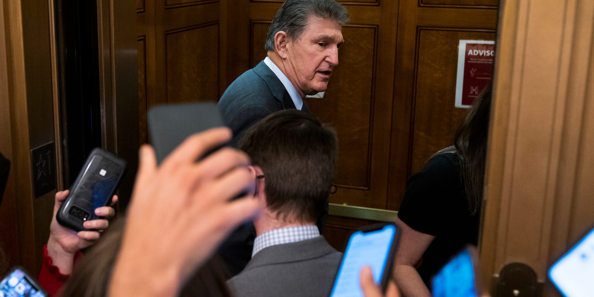 Democratic Sen. Joe Manchin of West Virginia is swarmed by reporters at the US Capitol on December 15, 2021.