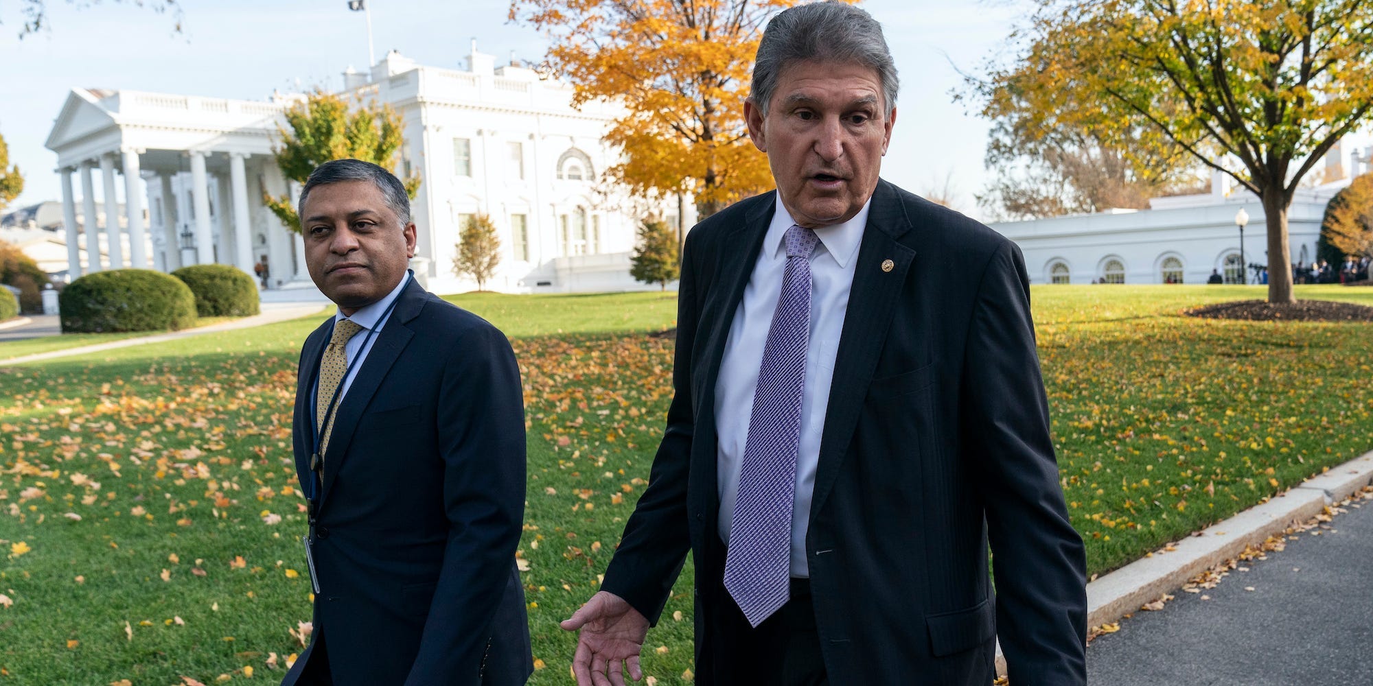 Dr. Rahul Gupta, left, the director of the White House Office of National Drug Control Policy, walks with Sen. Joe Manchin, D-W.Va., at the White House, Nov. 18, 2021, in Washington