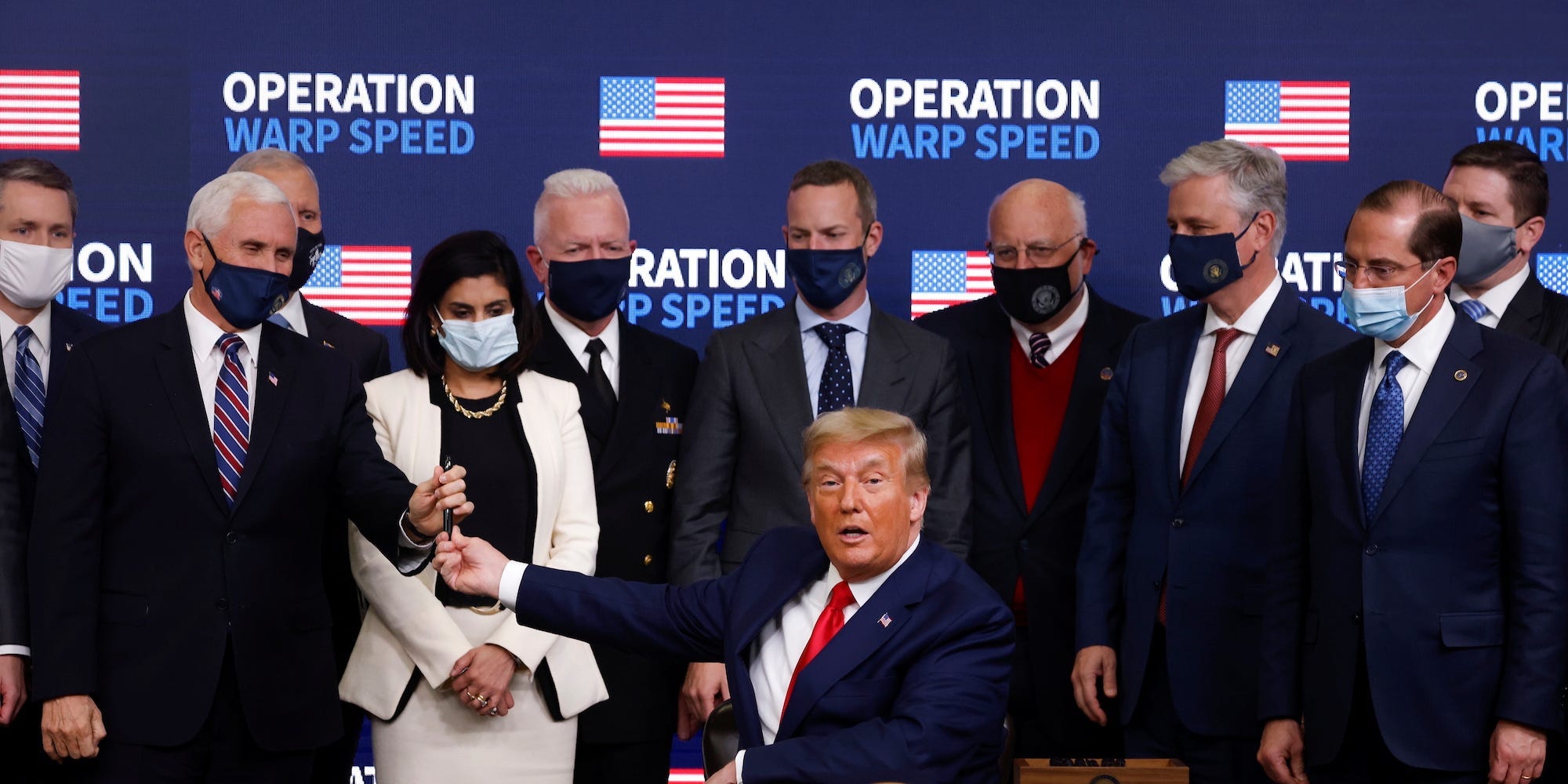 Former President Donald Trump signs an executive order on vaccine distribution at an Operation Warp Speed event on December 8, 2020.