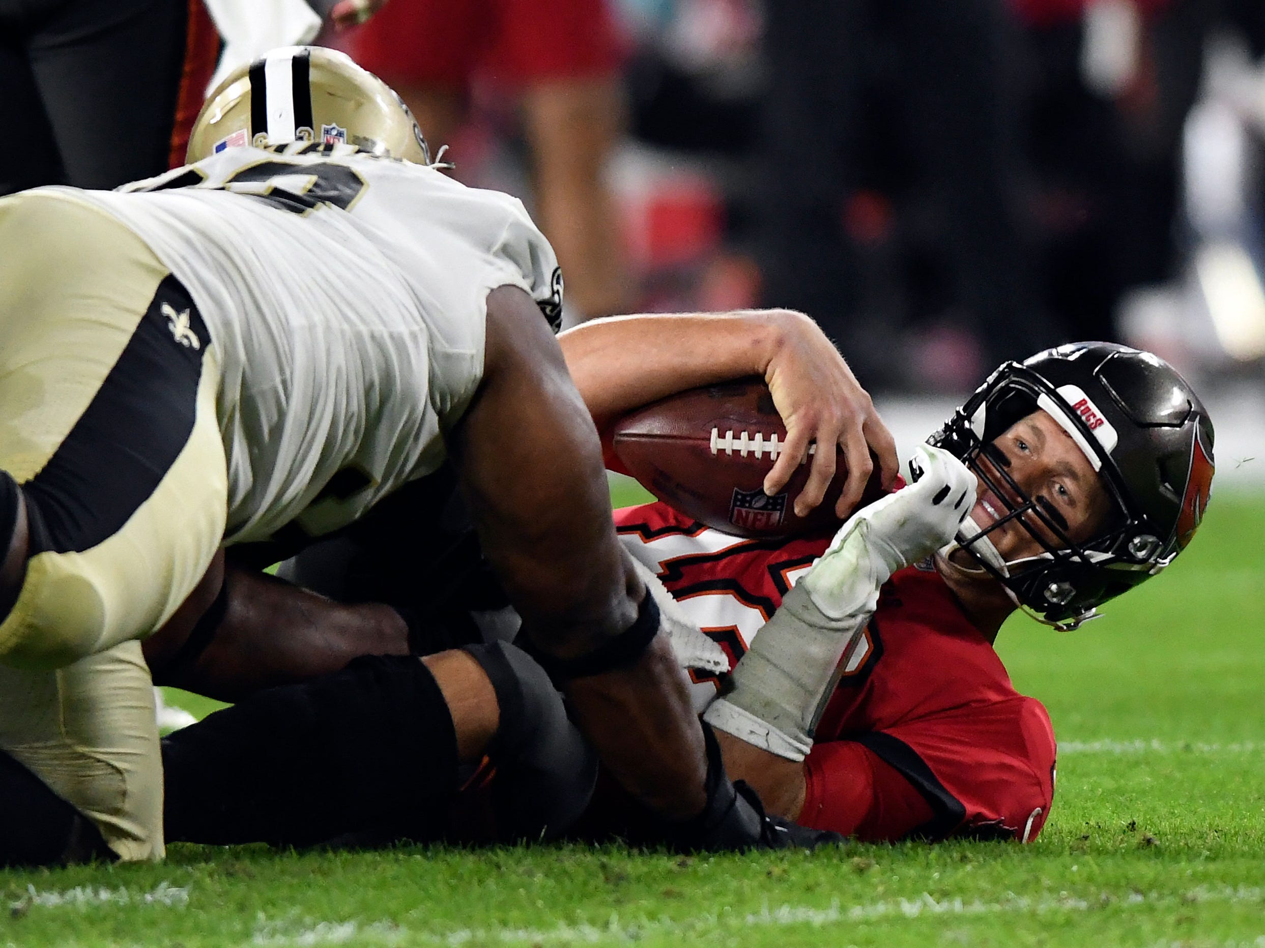 Tom Brady is sacked by the Saints defense.