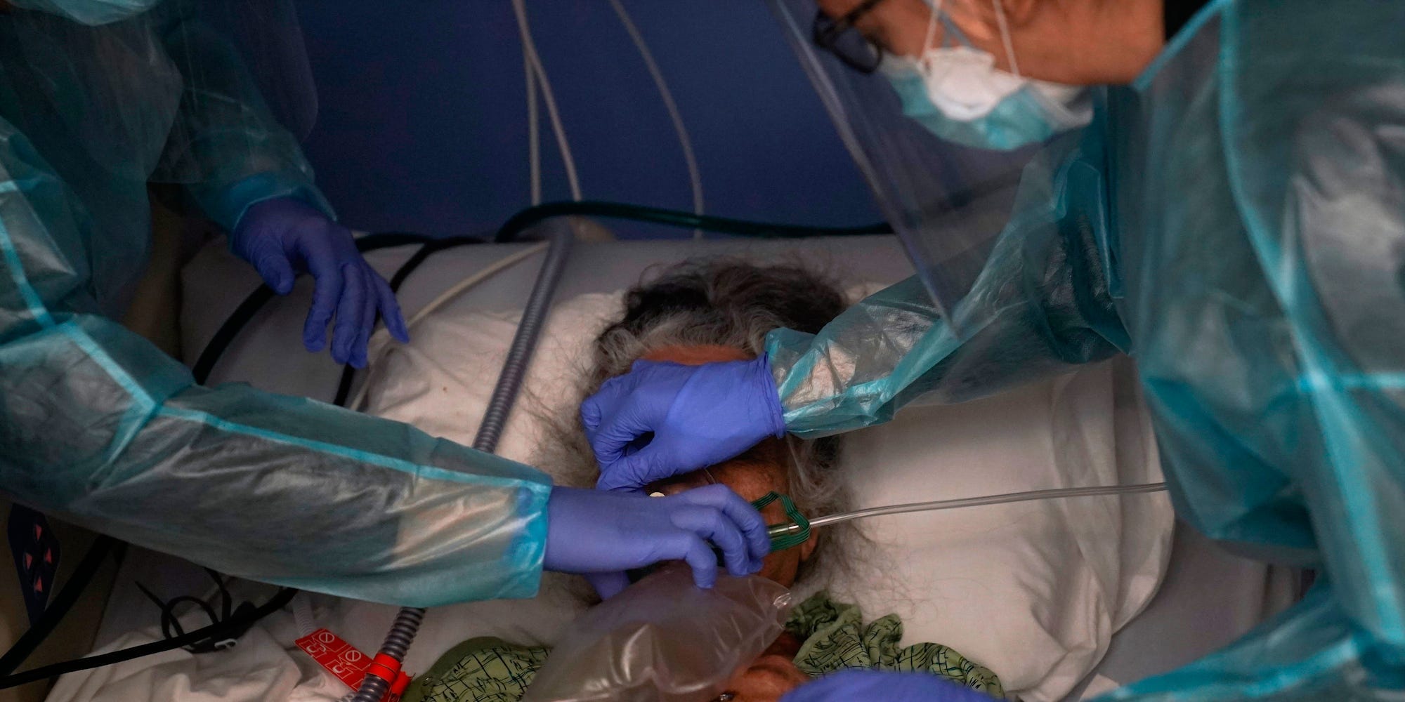 In this Jan. 7, 2021, file photo, two nurses put a ventilator on a patient in a COVID-19 unit in Orange, California.