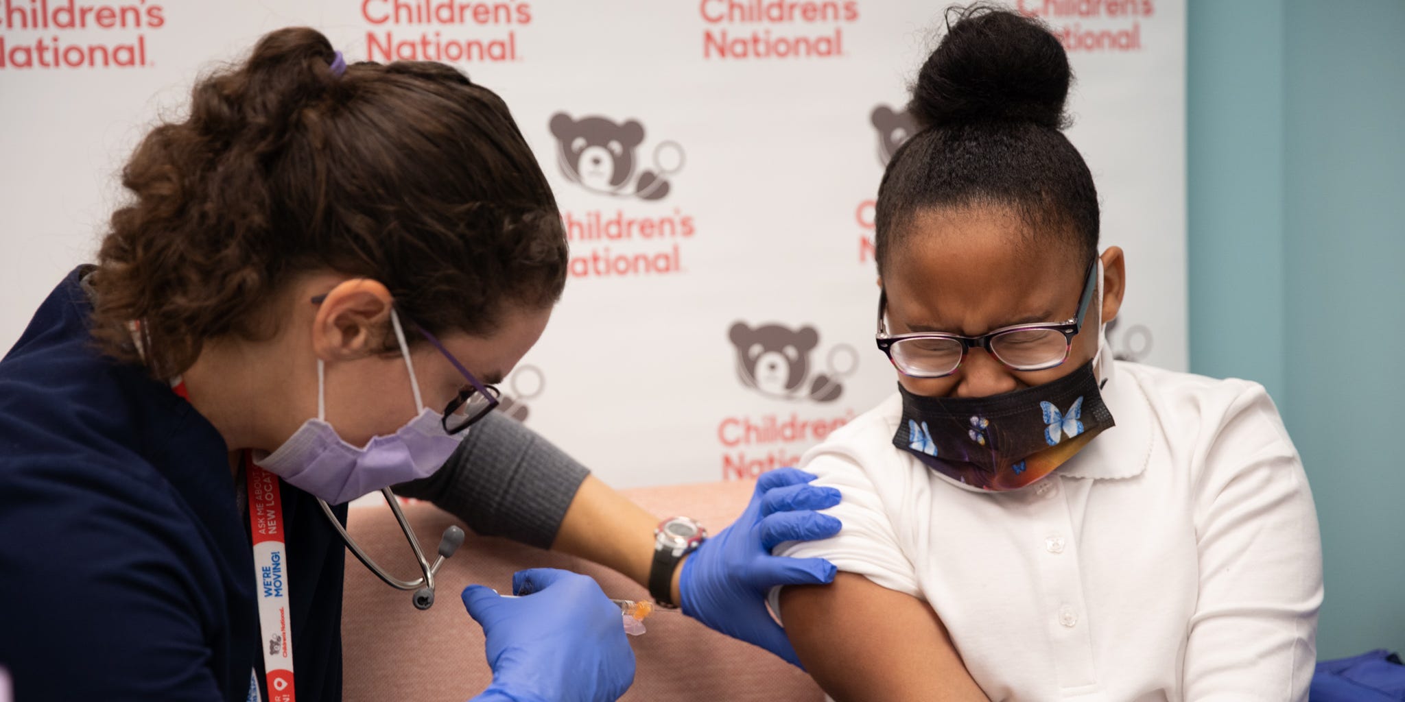 girl flinching at covid vaccine needle