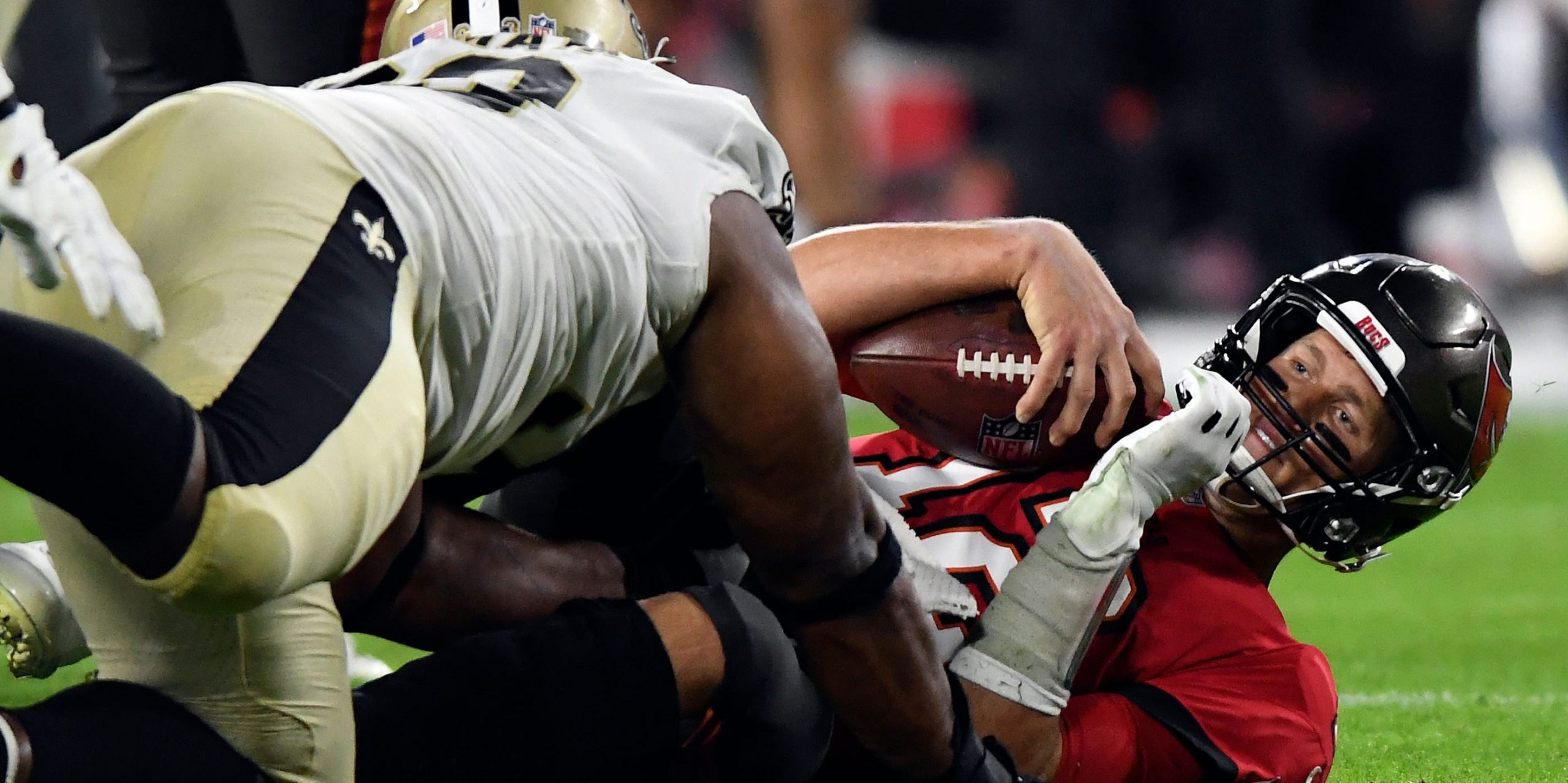 Tom Brady is sacked by the Saints defense.