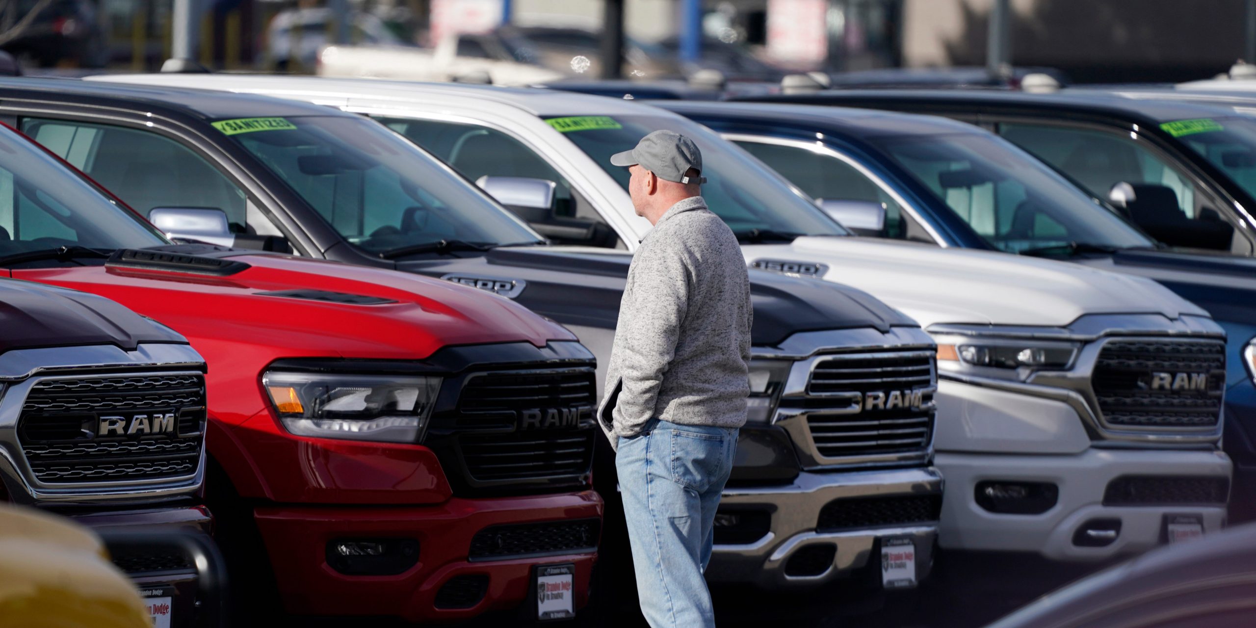 A car dealership lot with Ram pickup trucks.